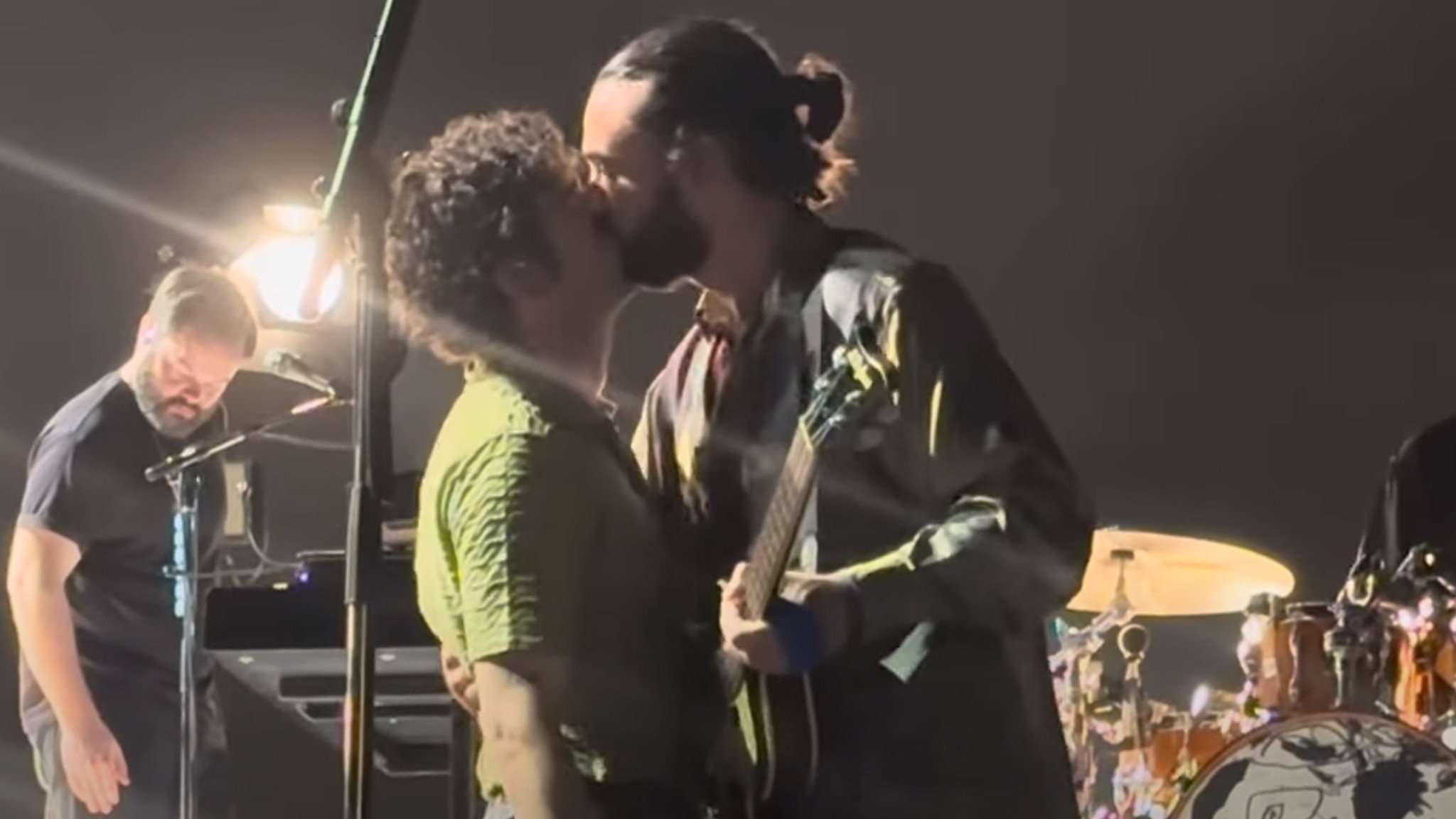 The 1975 singer Matty Healy kisses bandmate Ross MacDonald during a concert in Kuala Lumpur, Malaysia, in July 2023. The singer’s onstage LGBTQ-related rant raises questions about tourists visiting less tolerant countries than their own.