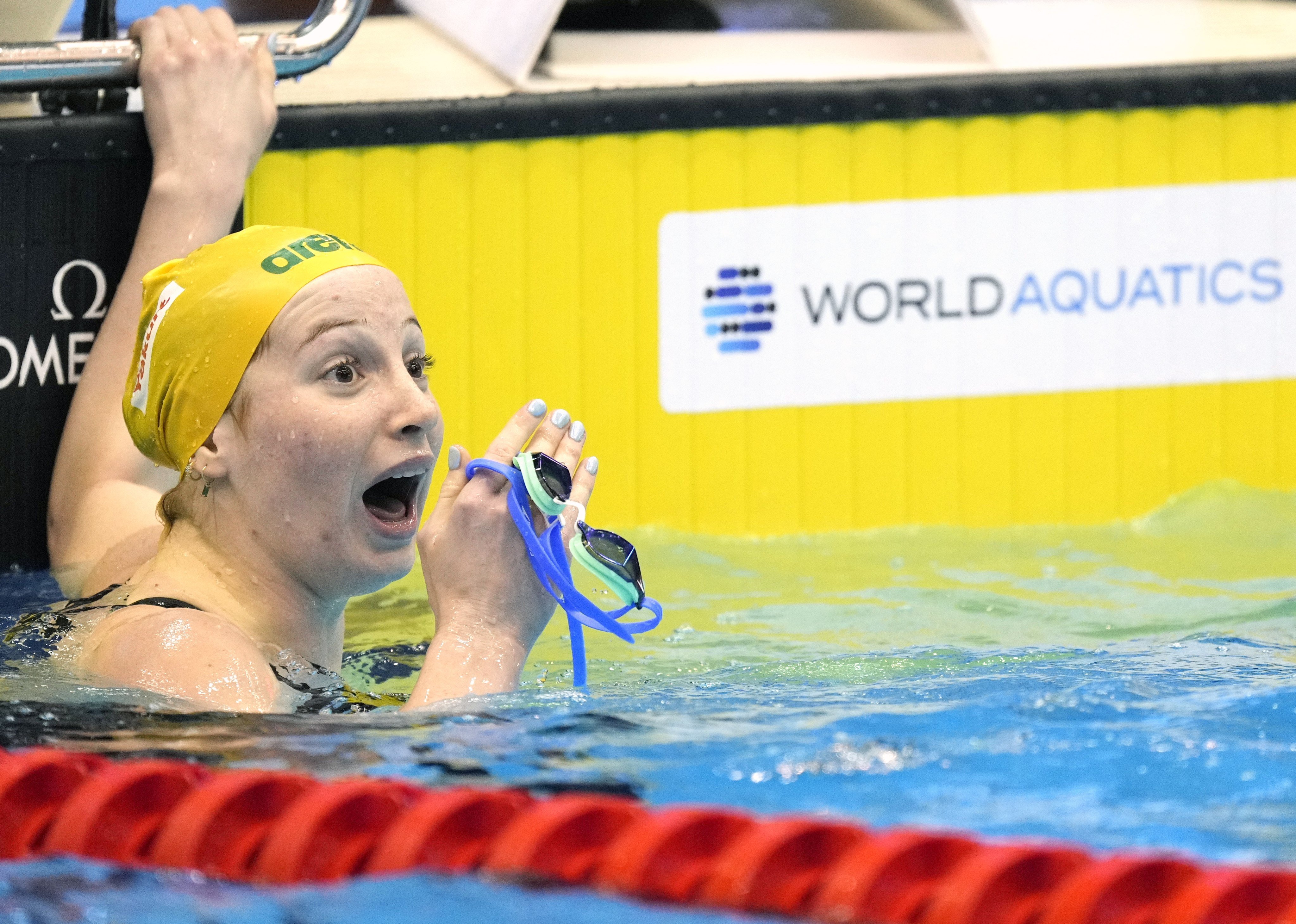 Mollie O’Callaghan of Australia realises she has set a new world record in winning the 200m freestyle in Fukuoka. Photo: EPA-EFE
