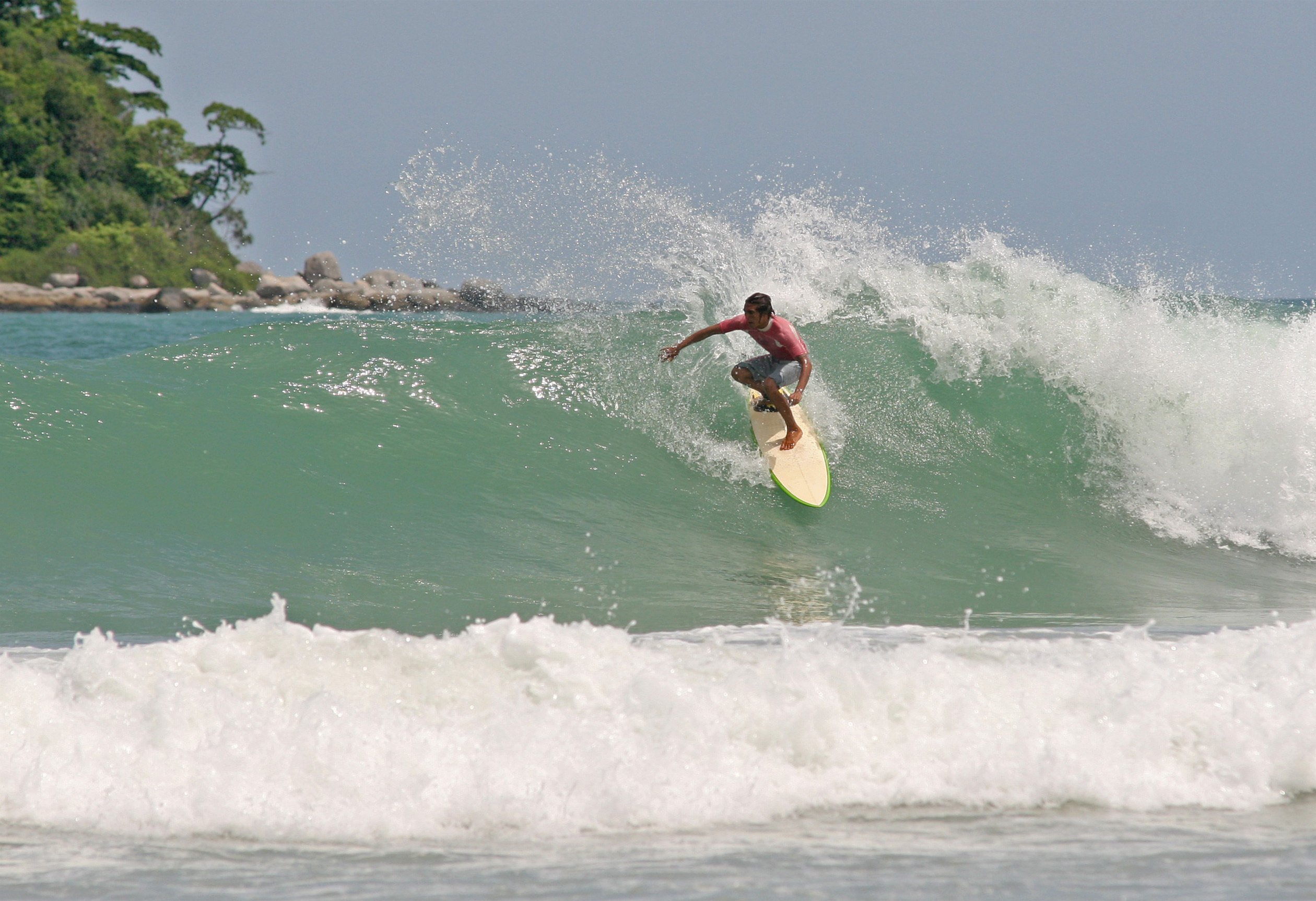 A surfer catches a wave in Phuket, Thailand. The island is making efforts to get in on the global surf tourism boom, which it could do as a place where novices can learn the sport. Photo: Shutterstock