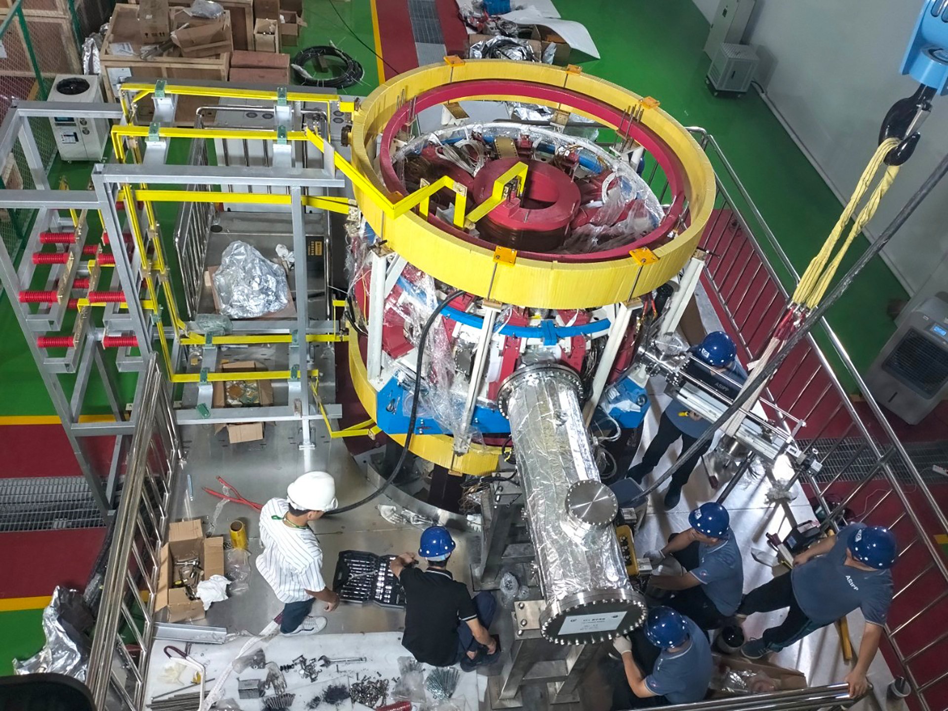 Chinese and Thai scientists work together to assemble and install the Thailand Tokamak-1. Photo: Handout