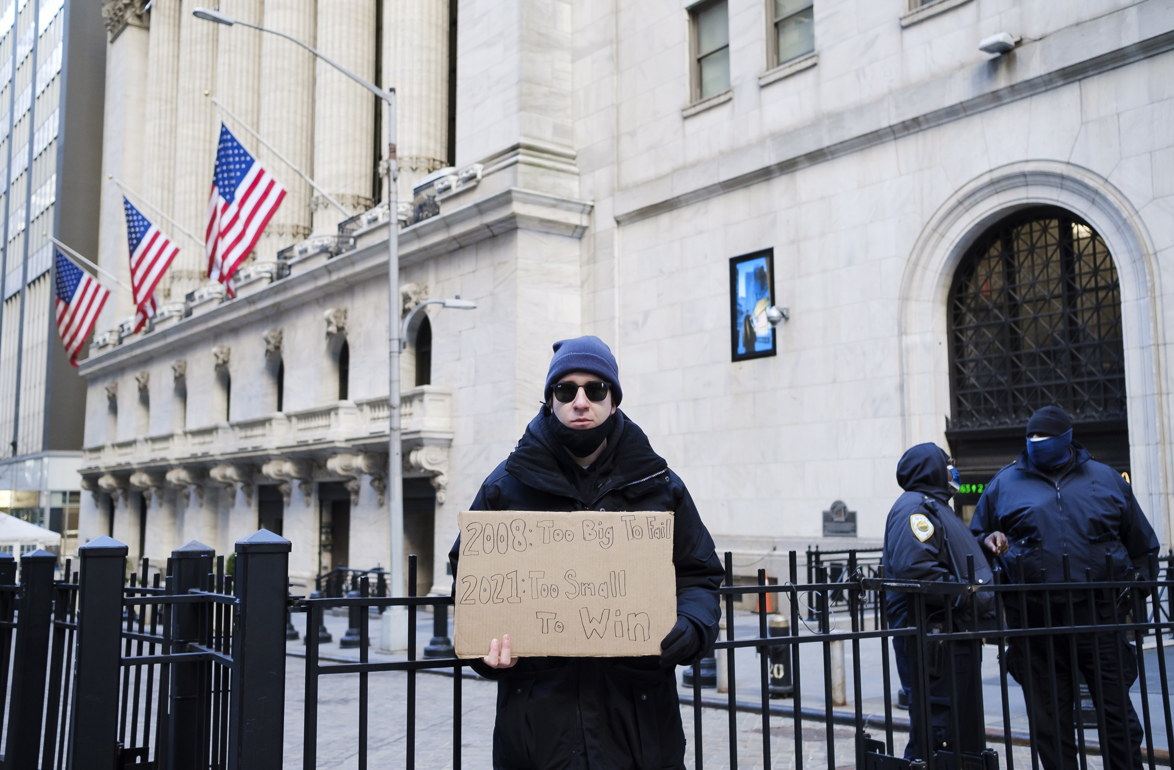 An activist stands in front of the New York Stock Exchange as part of a protest calling for an increase in the capital gains tax in New York, on January 28, 2021. Photo: EPA-EFE