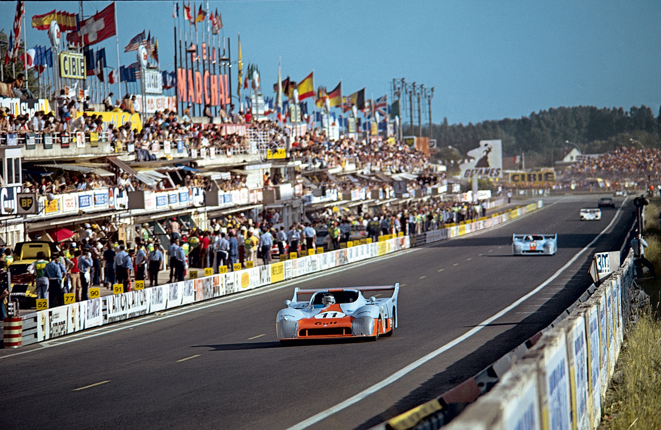 A colourful view of the pits area during the 1975 24 Hours of Le Mans race – a historic endurance event now celebrated in a book marking its centenary. Photo: Handout