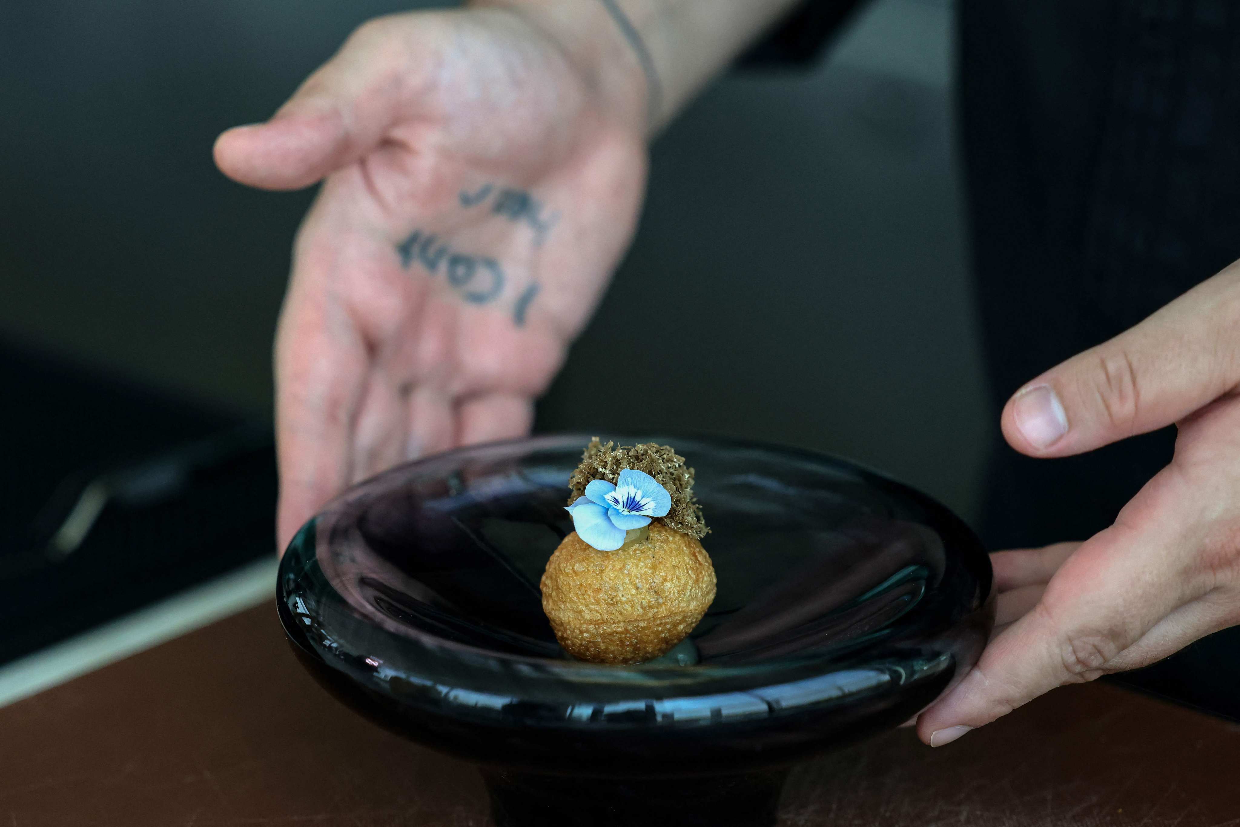 A chef prepares a dish at Moonrise Middle Eastern-Japanese fusion restaurant in Dubai. Photo: AFP