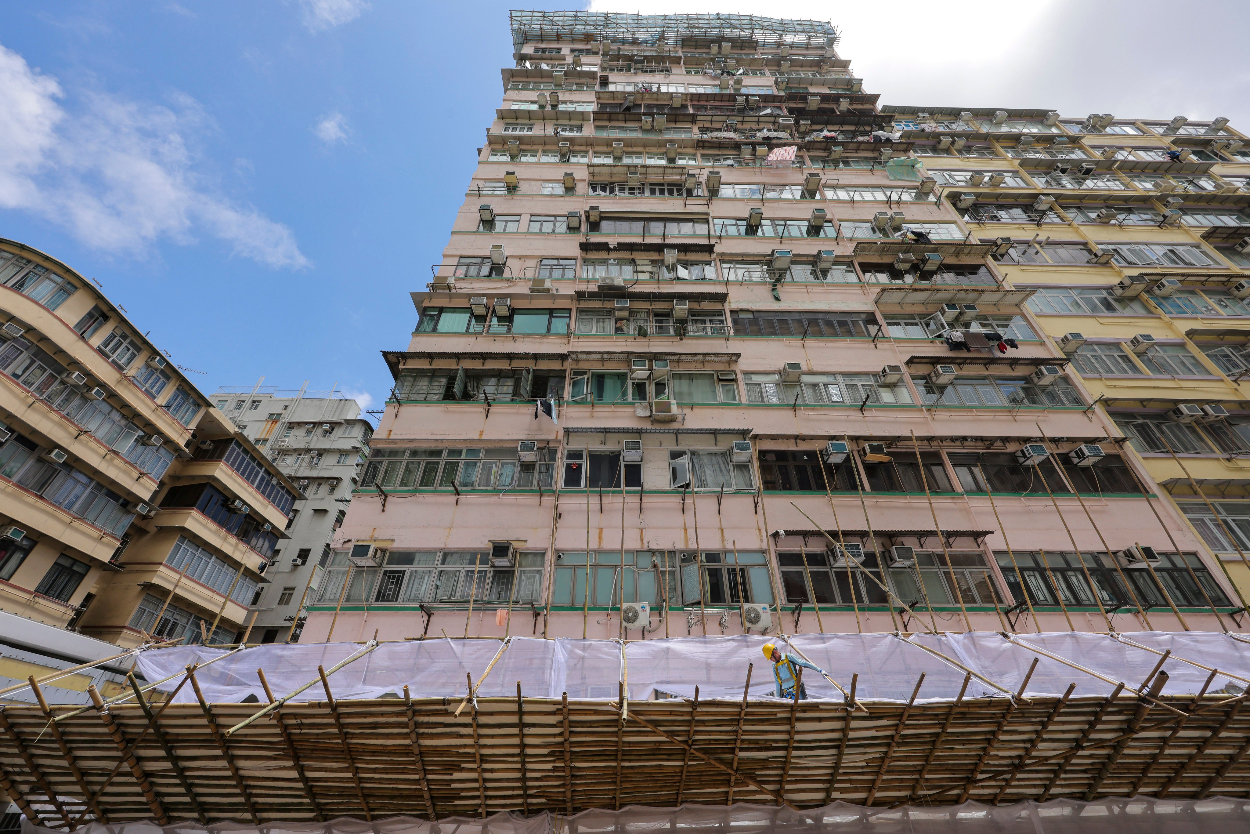 The Po On Building in Mong Kok is seen with scaffolding and protective nets on July 6. A rash of incidents of concrete and other parts of buildings falling onto pedestrians and into roads has refocused attention on building maintenance in Hong Kong. Photo: Jelly Tse