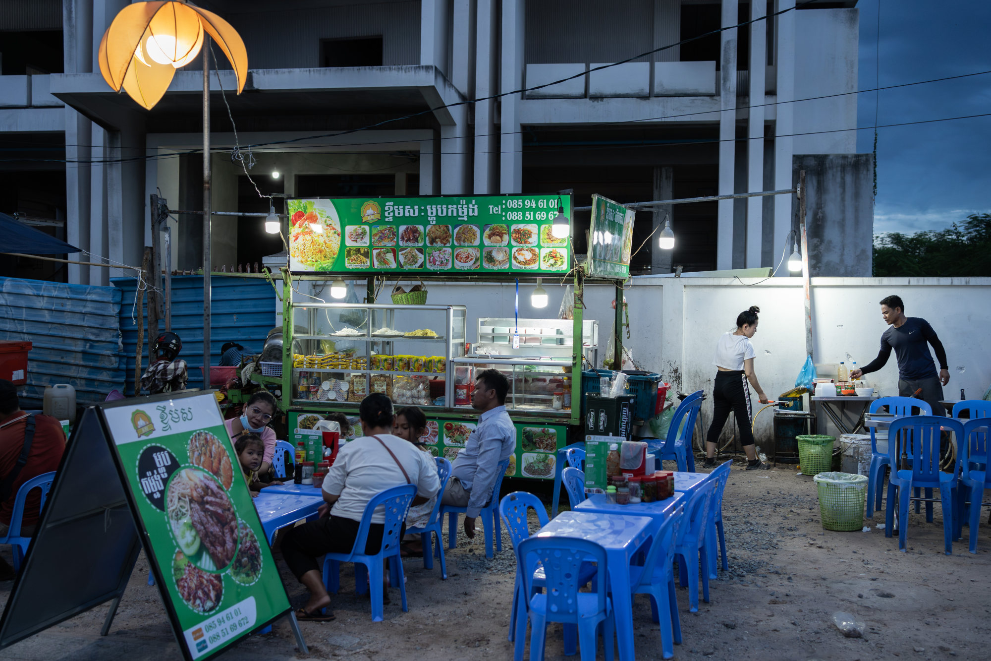 Chin Meas and his wife Kan Lida (right) work at their noodle stand in Siem Reap. Photo: Andy Ball