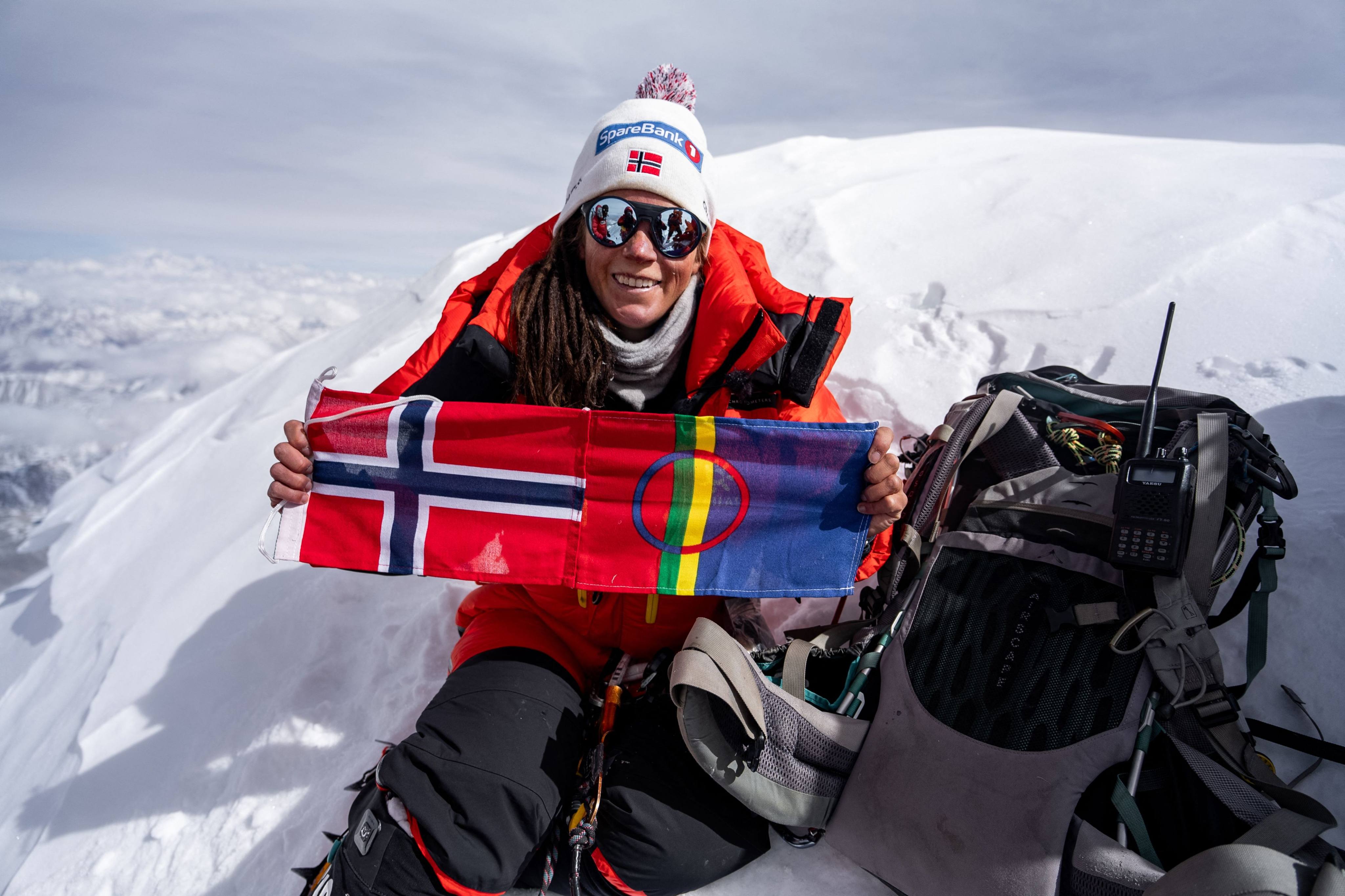 Norwegian climber Kristin Harila with her country flag at Shishapangma,  the14th-highest mountain in the world, located in China. Photo: AFP