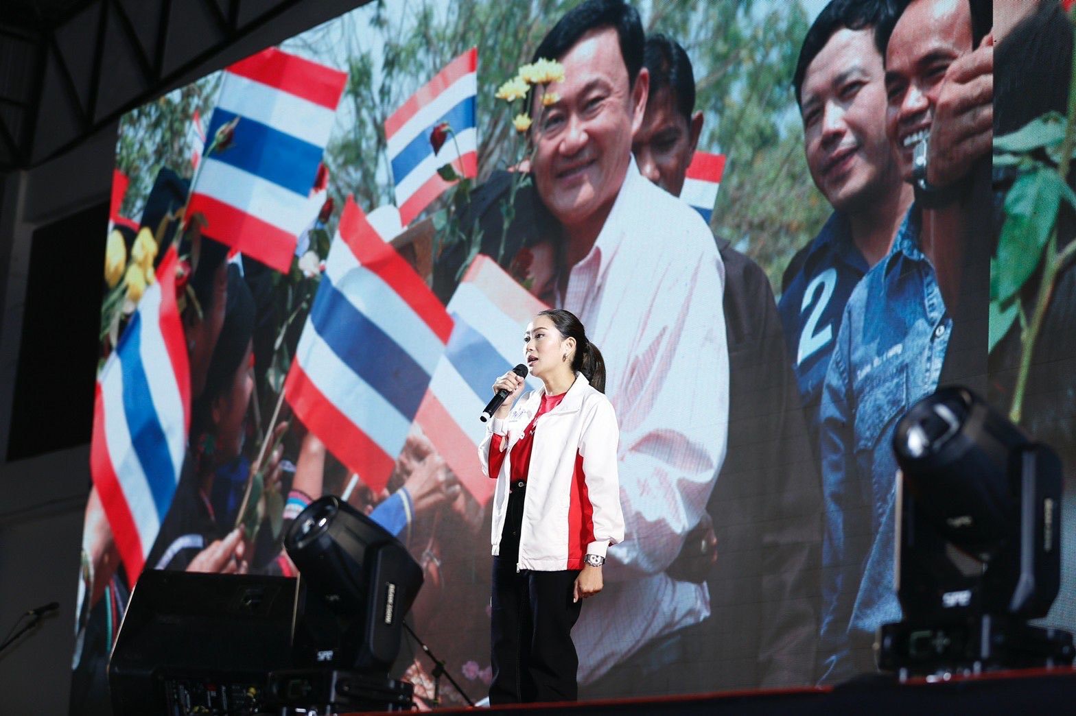 Paetongtarn Shinawatra at a rally on August 7 in front of an image of her father, ex-prime minister Thaksin. Photo: Handout