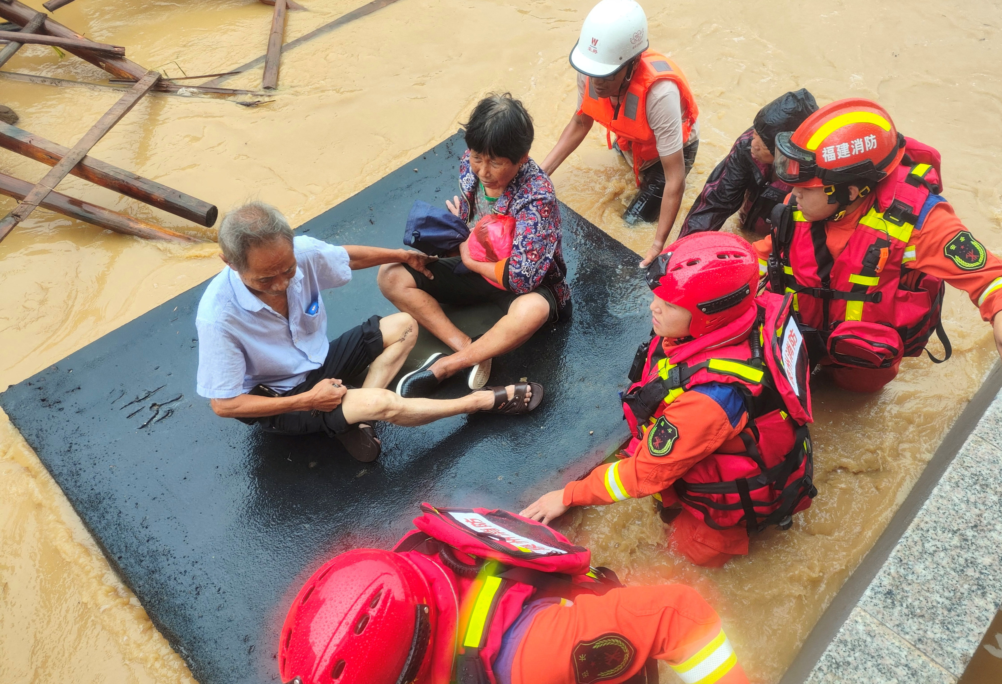 Firefighters evacuate residents after Typhoon Doksuri causes flooding in China’s Fujian province on Friday. Photo: cnsphoto via Reuters