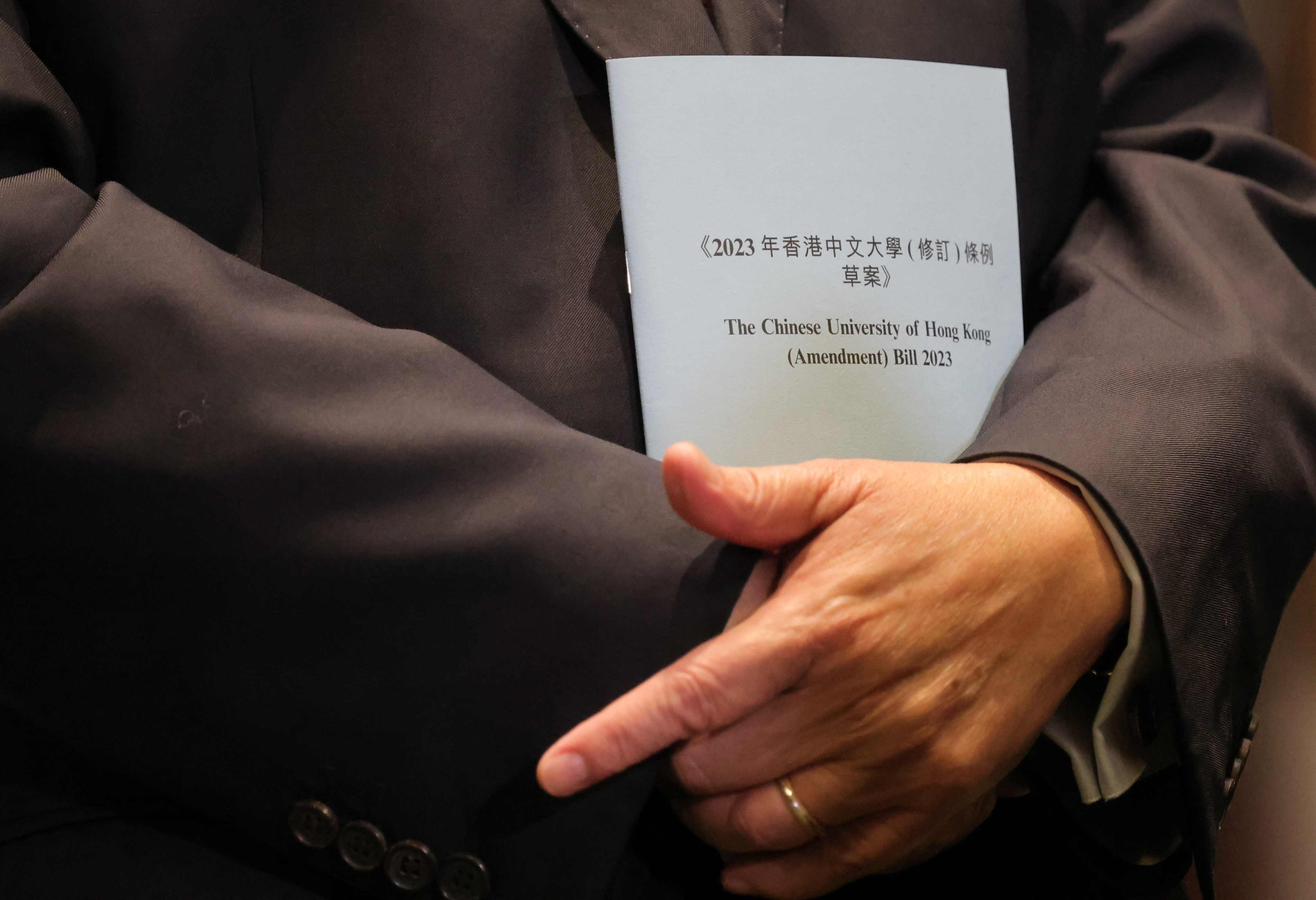Lawmaker Tommy Cheung holds a copy of the Chinese University of Hong Kong (Amendment) Bill 2023, a private members’ bill initiated by him and two other lawmakers, on June 27. Photo: Jelly Tse