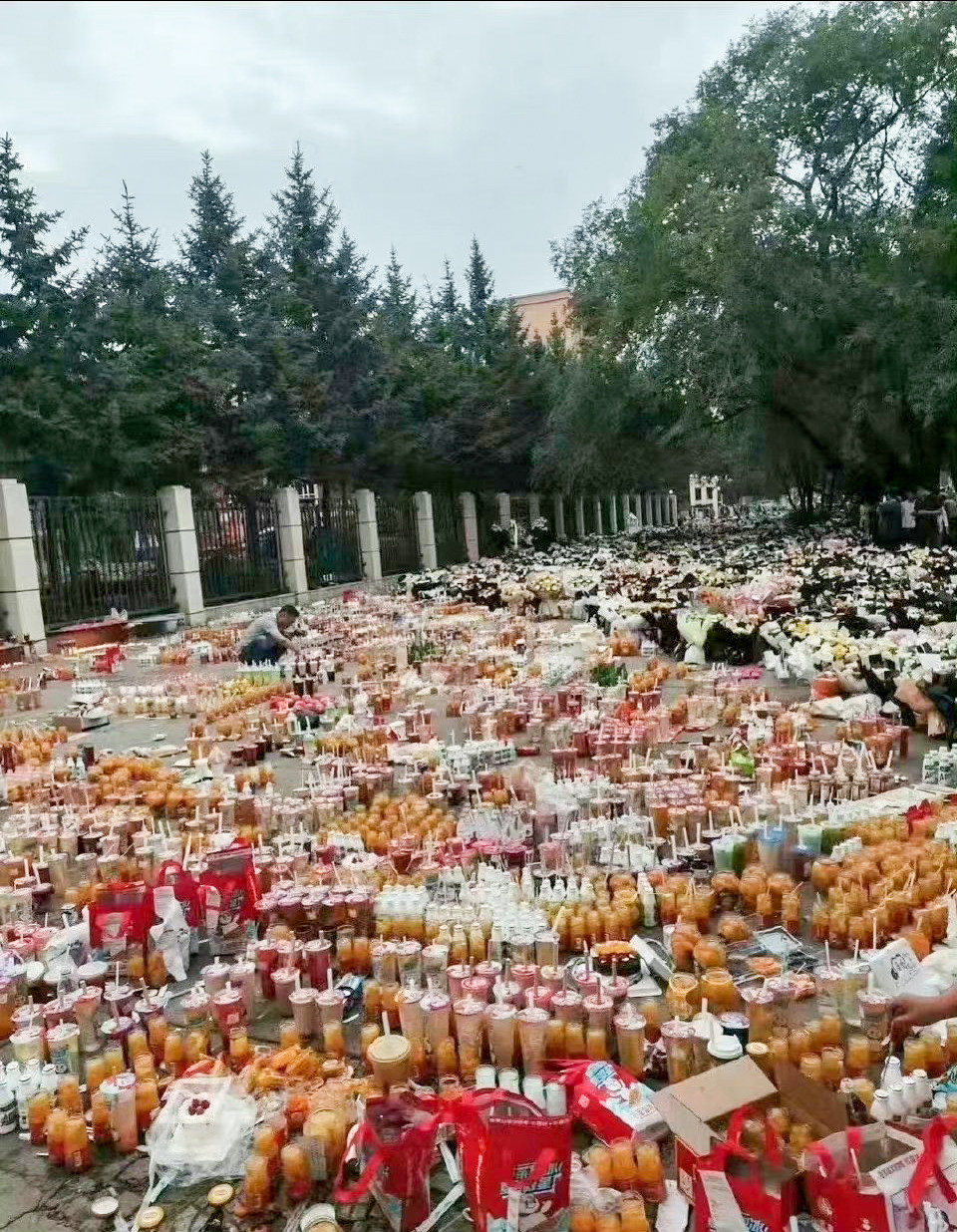 Bubble tea and snacks were laid outside the school in Qiqihar to honour the dead.  Photo: Weibo