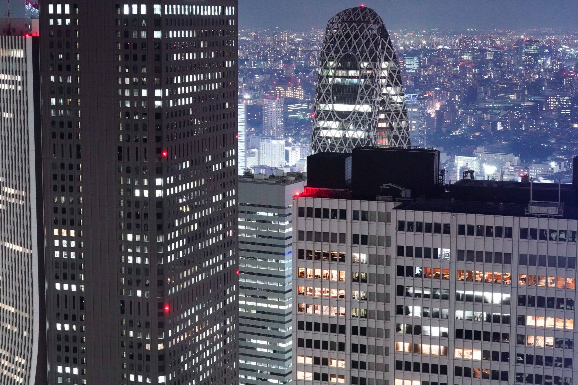 Office buildings are illuminated at night in Tokyo on July 21. The average vacancy rate for grade A offices in Tokyo was the second-lowest in the Asia-Pacific region. Photo: Bloomberg