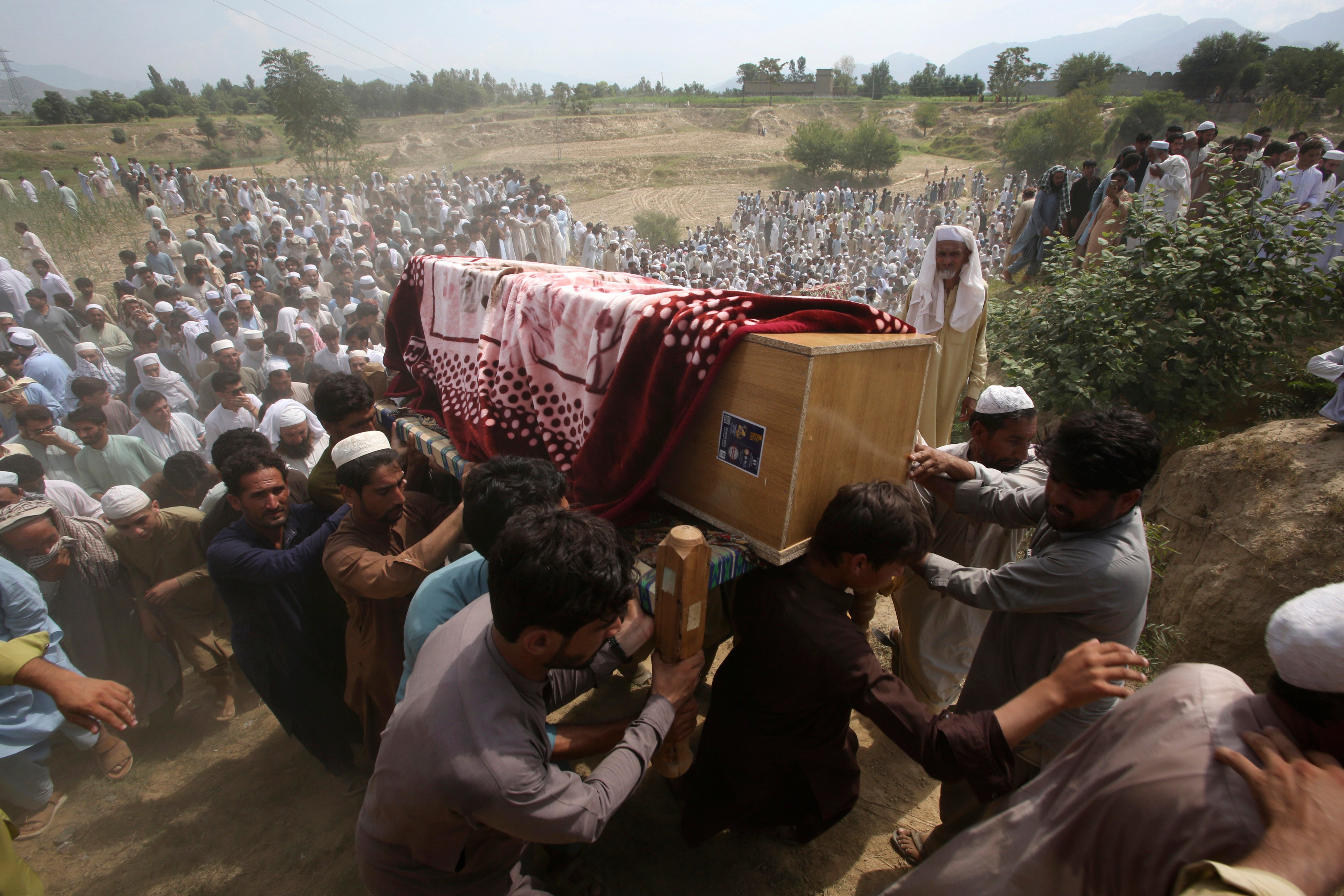 Mourners carry the casket of a victim of Sunday’s suicide bomb attack in the Bajur district of Khyber Pakhtunkhwa, Pakistan on Monday. Photo: AP