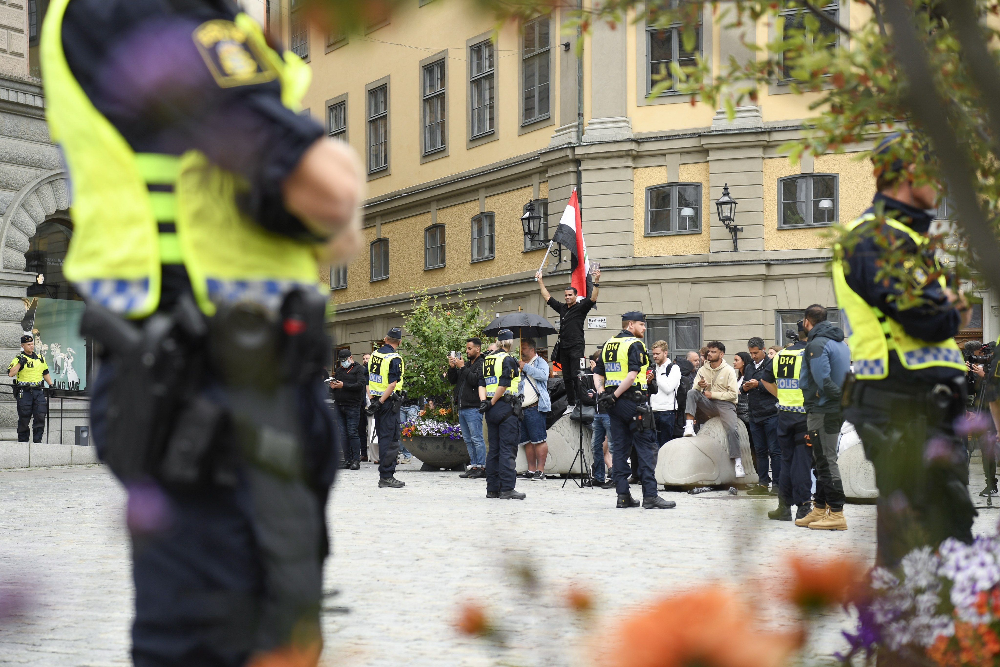 Police stand guard in Stockholm, Sweden, on Monday, close to where a man prepares to burn a copy of the Koran. There have been similar incidents before, which have caused uproar in some Muslim nations. Photo: EPA-EFE
