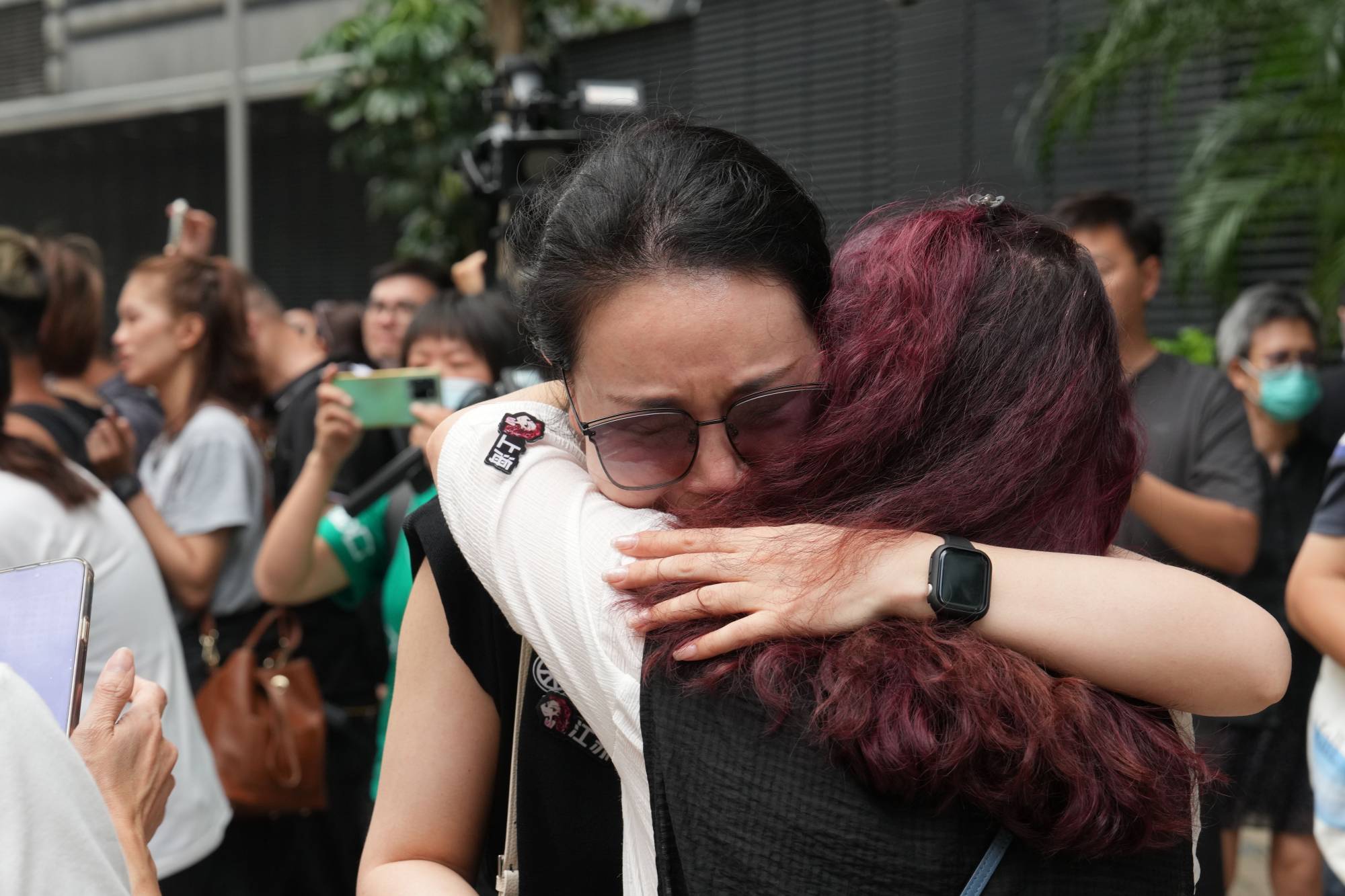 Lee supporters get emotional as the hearse leaves the funeral venue. Photo: Elson Li