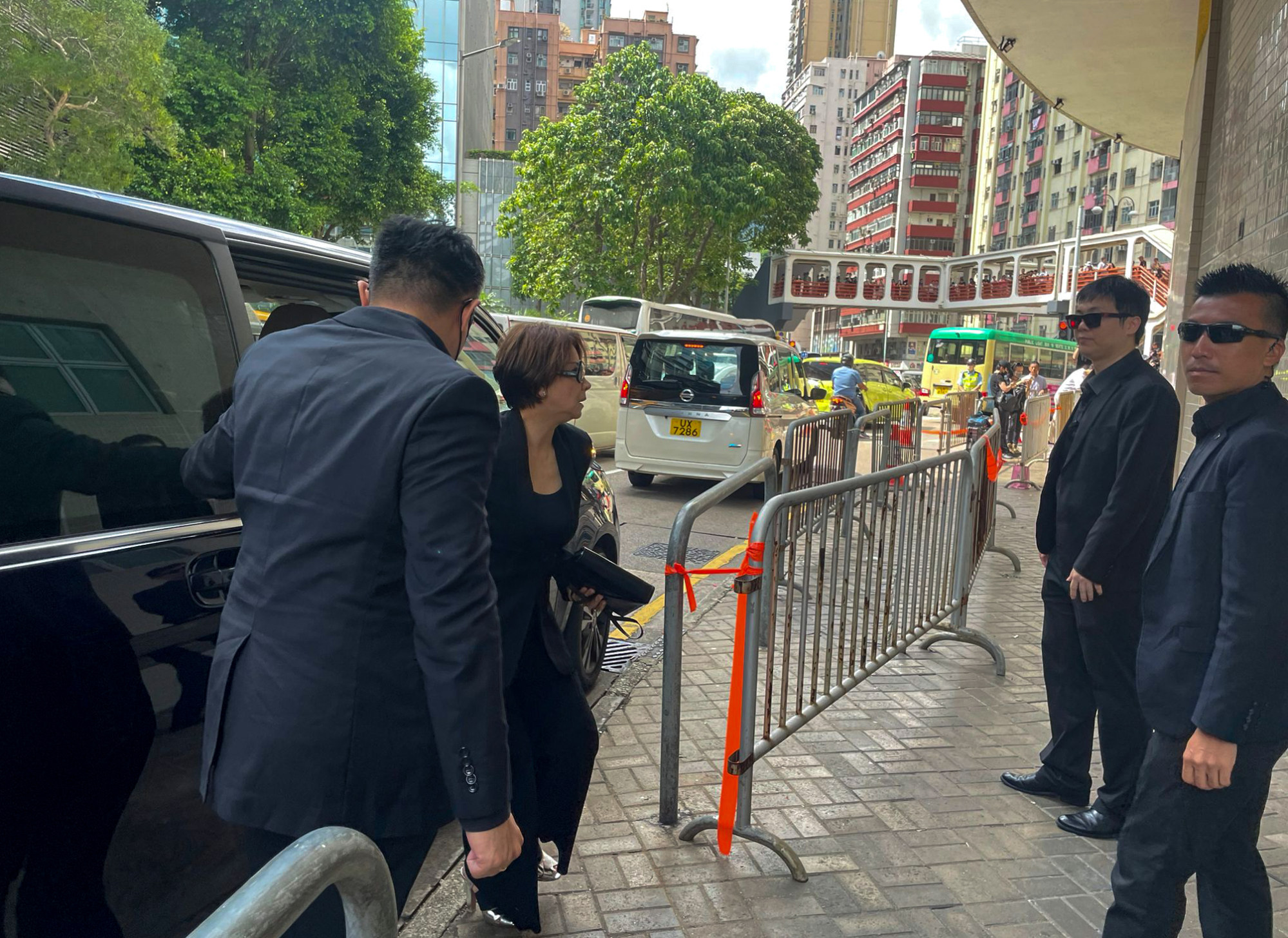 Hong Kong singer Jenny Tseng, one of the pallbearers, arrives at the funeral home. Photo: Lars Hamer