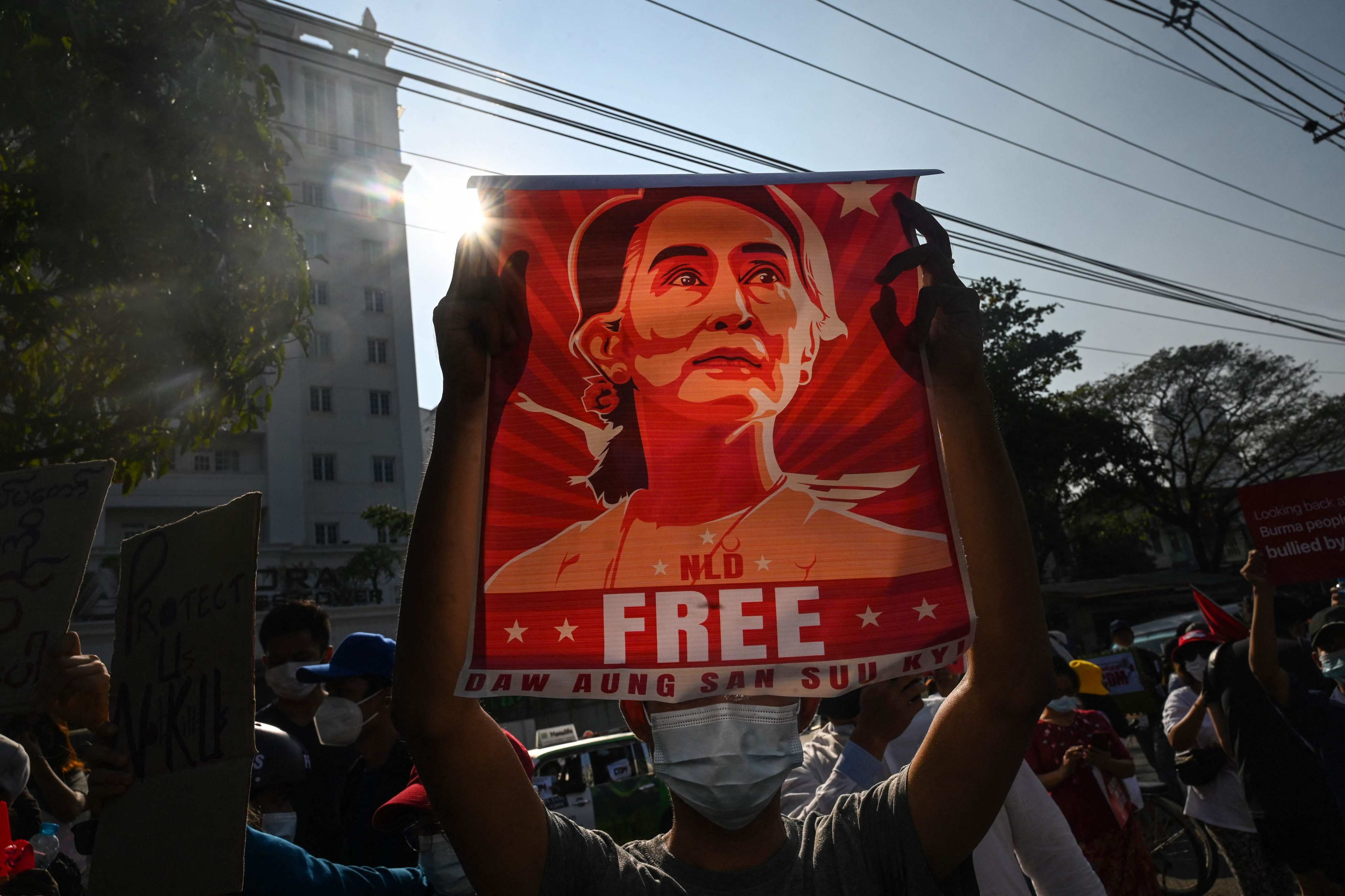 A protester in Yangon holds up a poster featuring Aung San Suu Kyi during a demonstration in February 2021 against the military coup. Suu Kyi was sentenced to a total of 33 years imprisonment following the coup. Photo: AFP