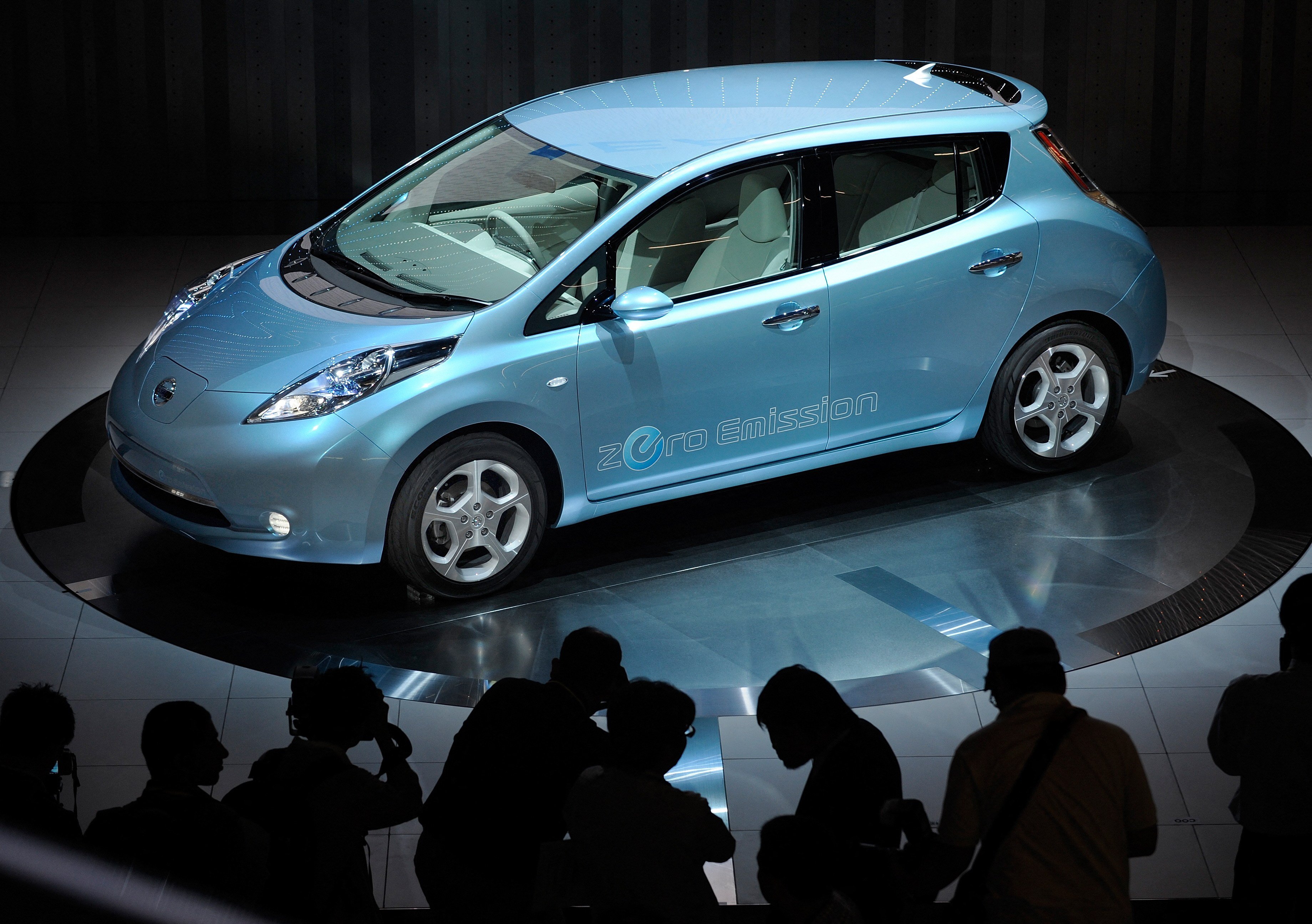 Photographers take pictures of Nissan Motor’s electric vehicle called “Leaf”. Photo: AFP