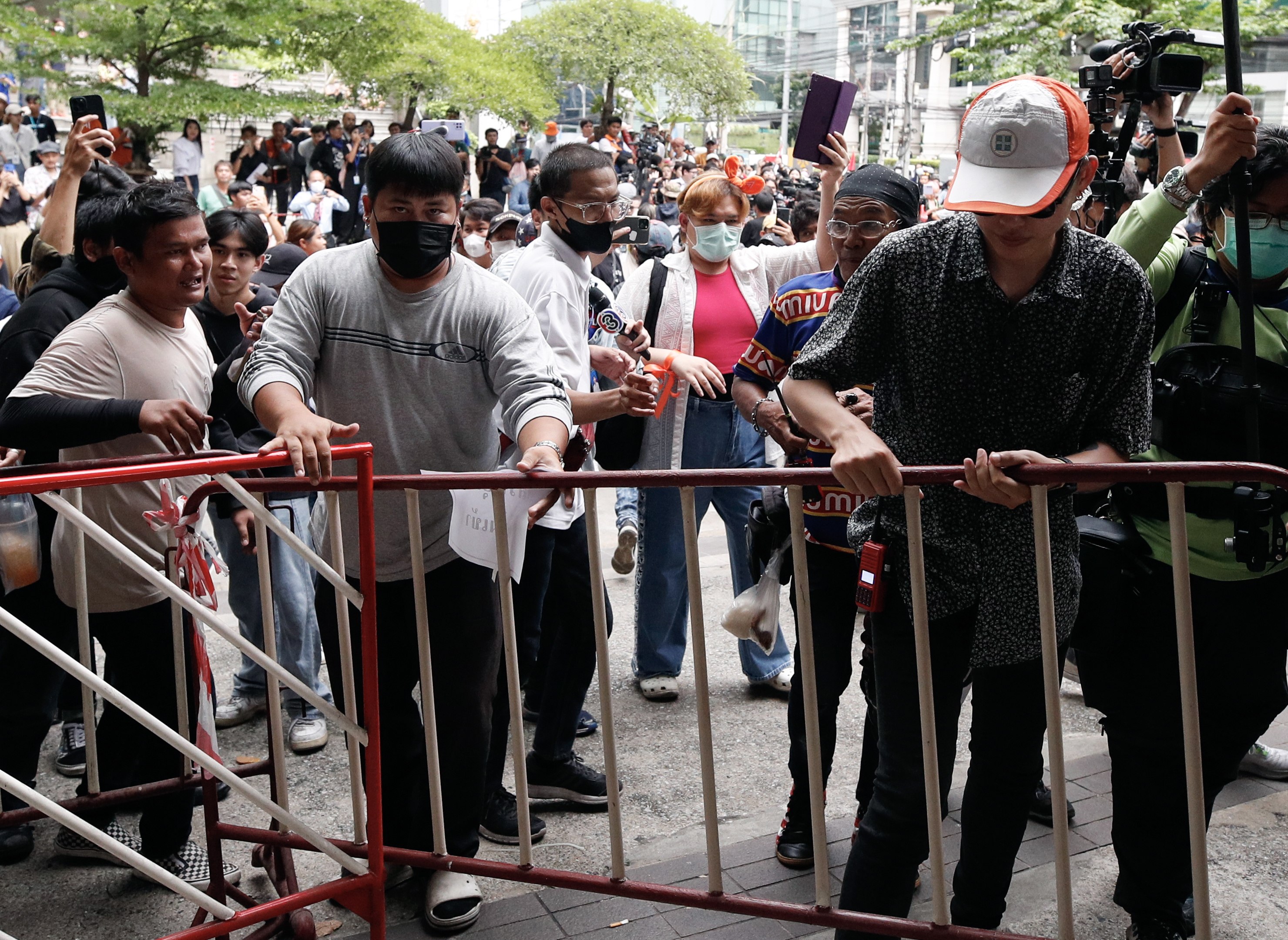 Supporters of Thailand’s election-winning Move Forward Party try to remove barricades during a protest on Wednesday over its exclusion from the coalition that is trying to form a government. Photo: EPA-EFE