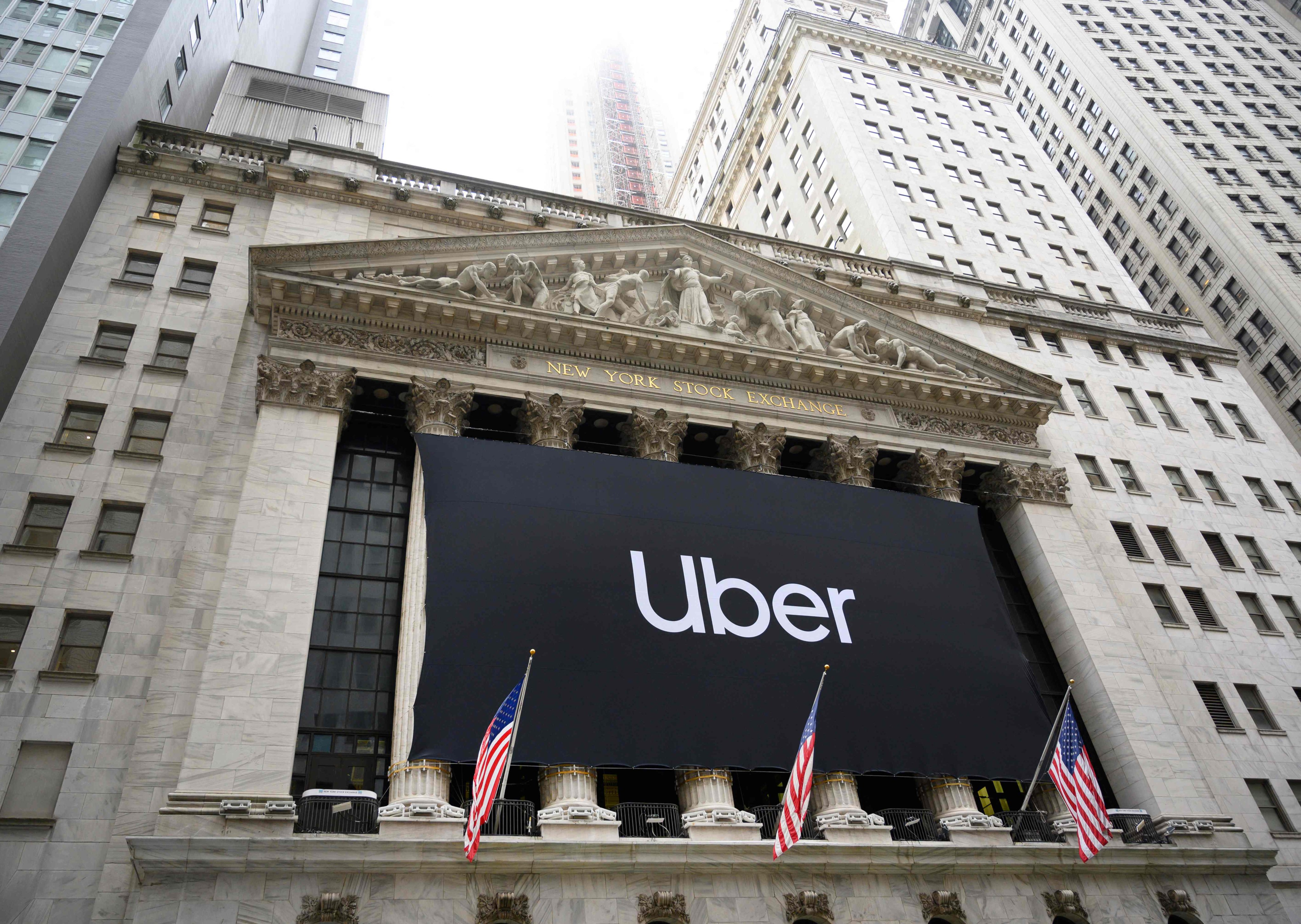 An Uber banner adorns the facade of the New York Stock Exchange ahead of the ride-sharing company’s initial public offering on May 10, 2019. Photo: AFP