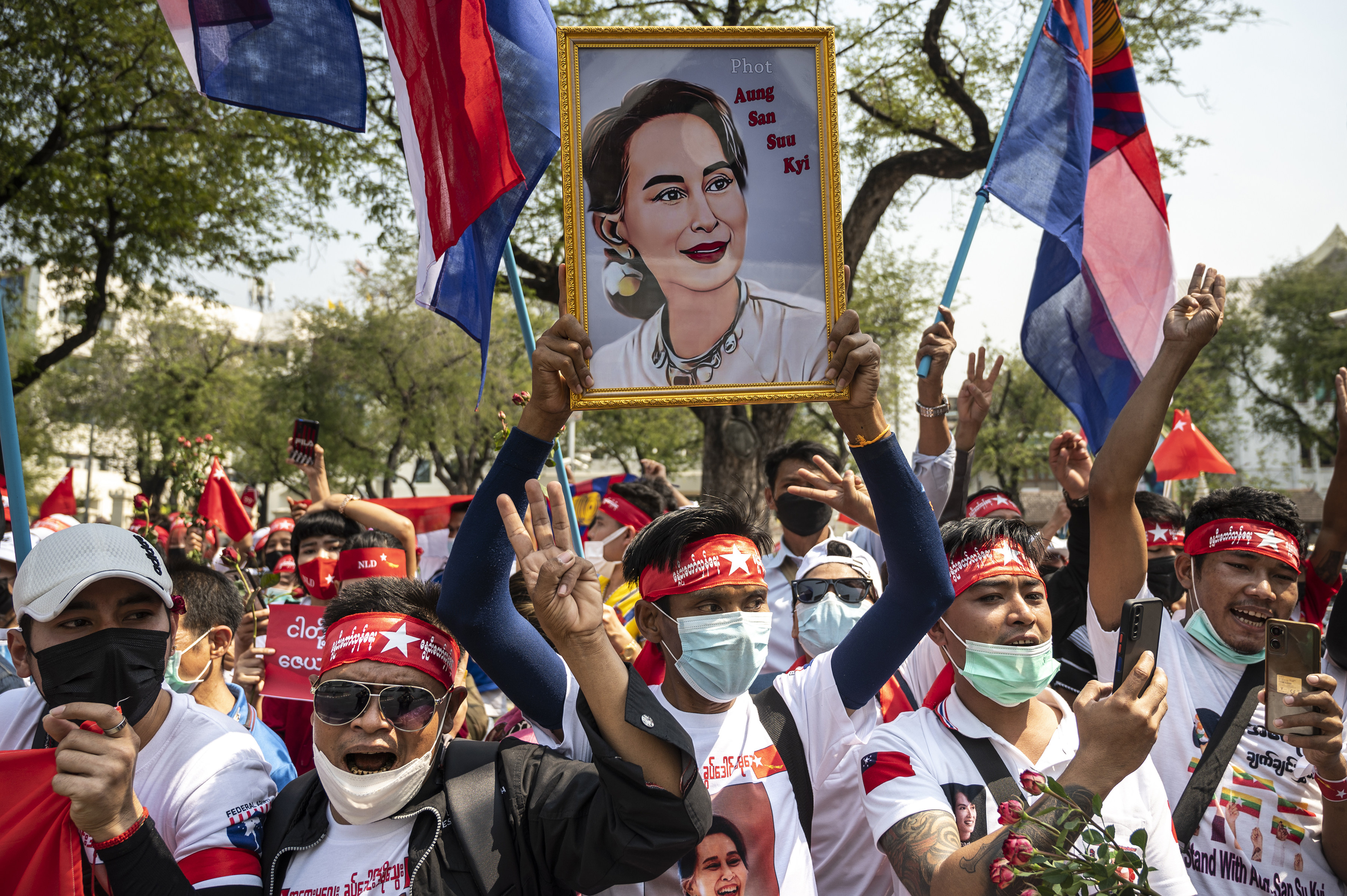 Myanmar activists hold up portraits of Aung San Suu Kyi at an anti-junta demonstration in front of the United Nations building in Bangkok, Thailand. Photo: Getty Images/TNS