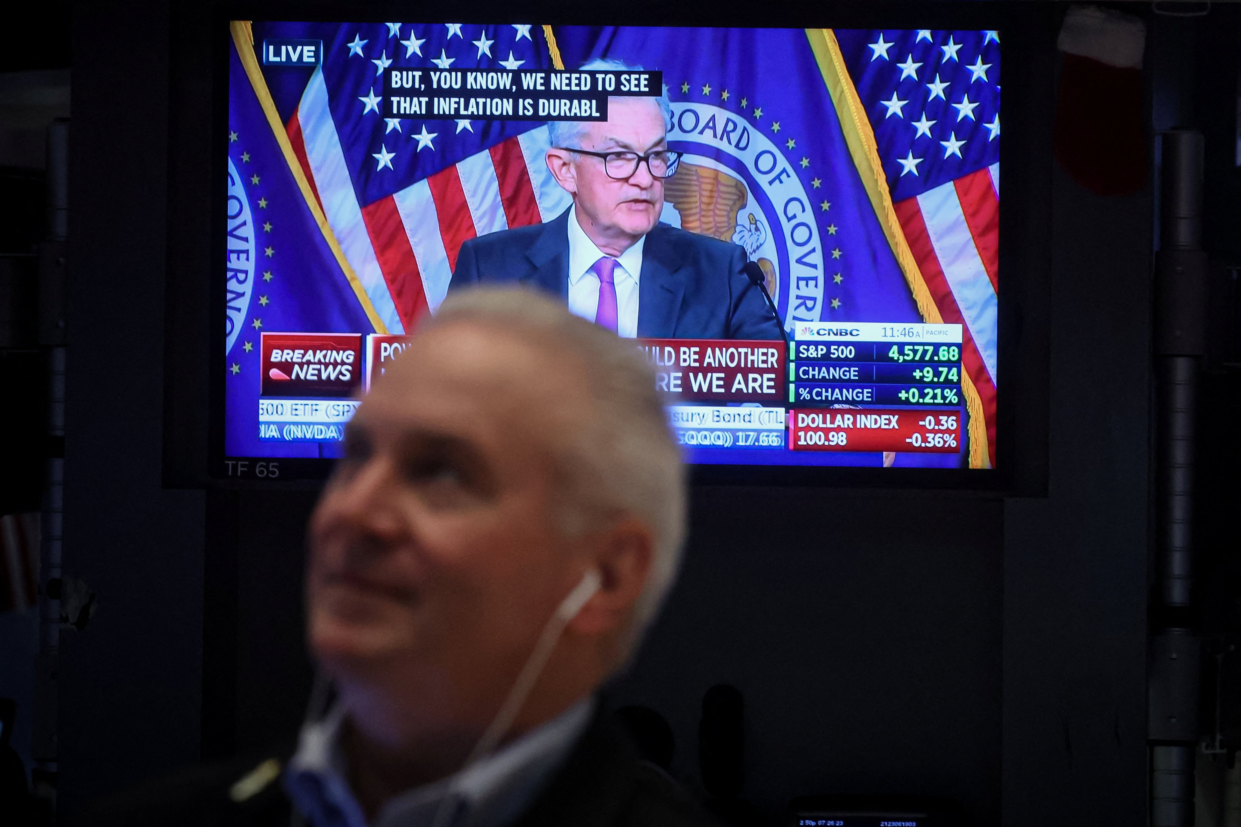 A trader works  on the floor of the New York Stock Exchange on July 26, as a screen displays a news conference by US Federal Reserve chairman Jerome Powell following the Fed rate announcement. Photo: Reuters