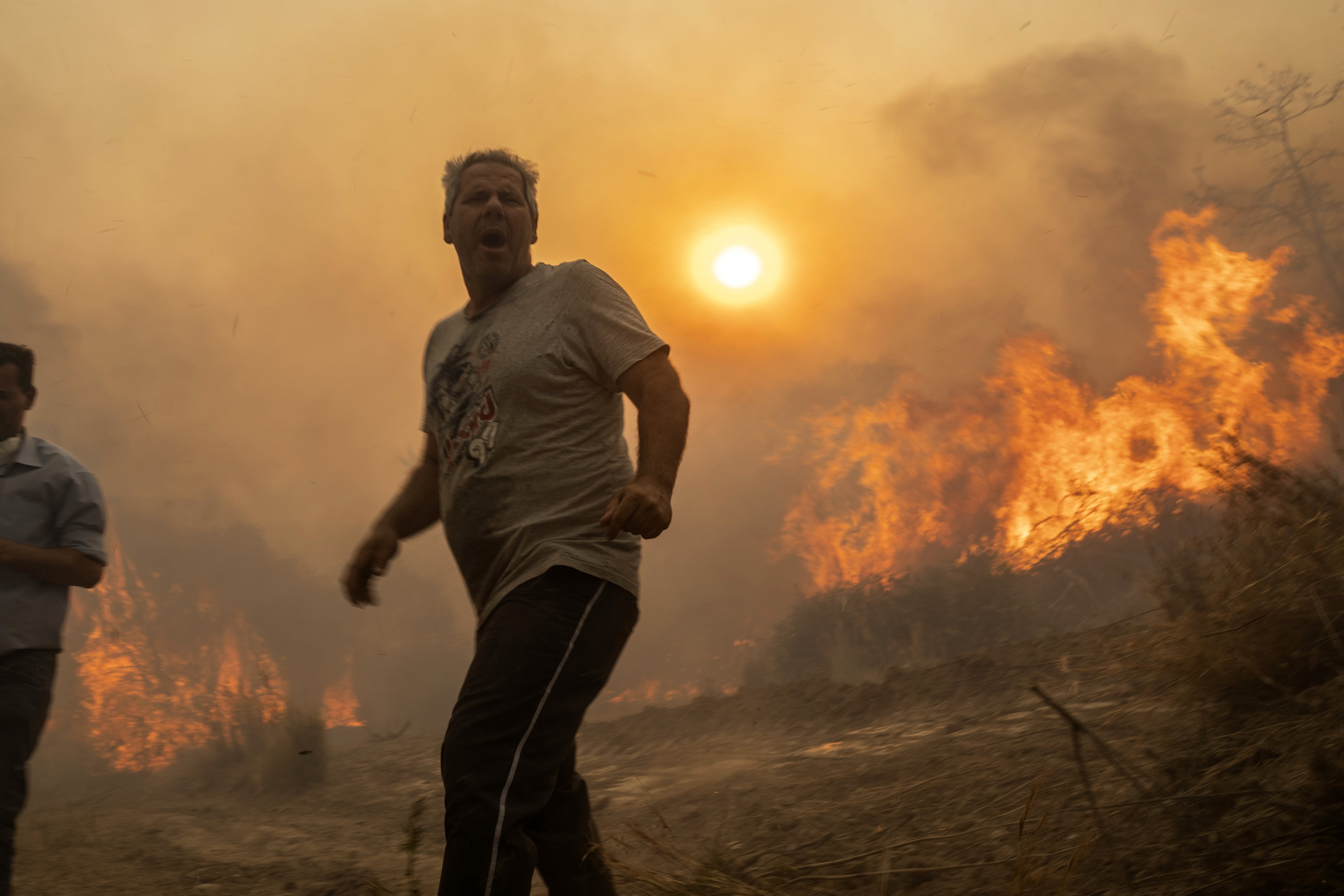 A local man reacts as trees burn in Gennadi village on the Aegean Sea island of Rhodes in southeastern Greece on July 25. Photo: AP
