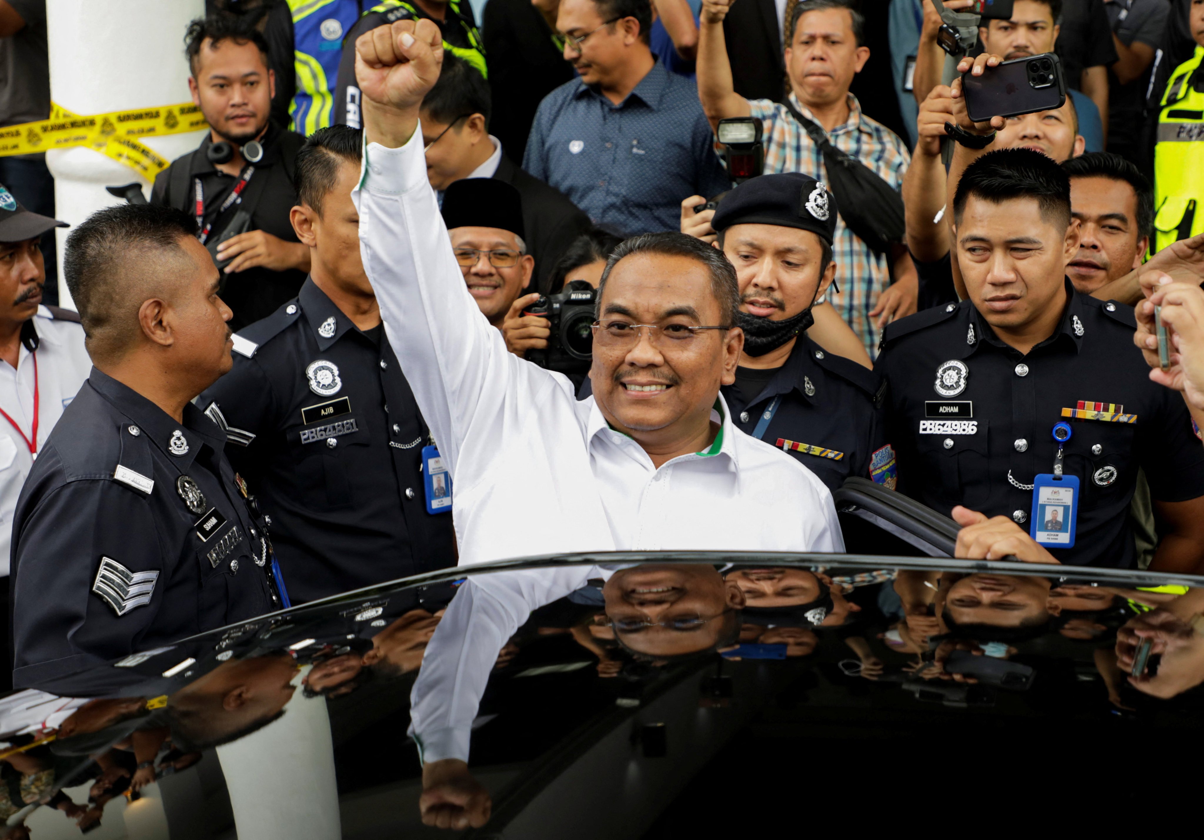 Malaysian opposition leader Muhammad Sanusi Md Nor raises his fist as he leaves a court where he was charged in Gombak, Malaysia on July 18. His decision to ban gambling and clamp down on alcohol has made him very popular in a state where more than 80 per cent of people are Muslims. Photo: Reuters