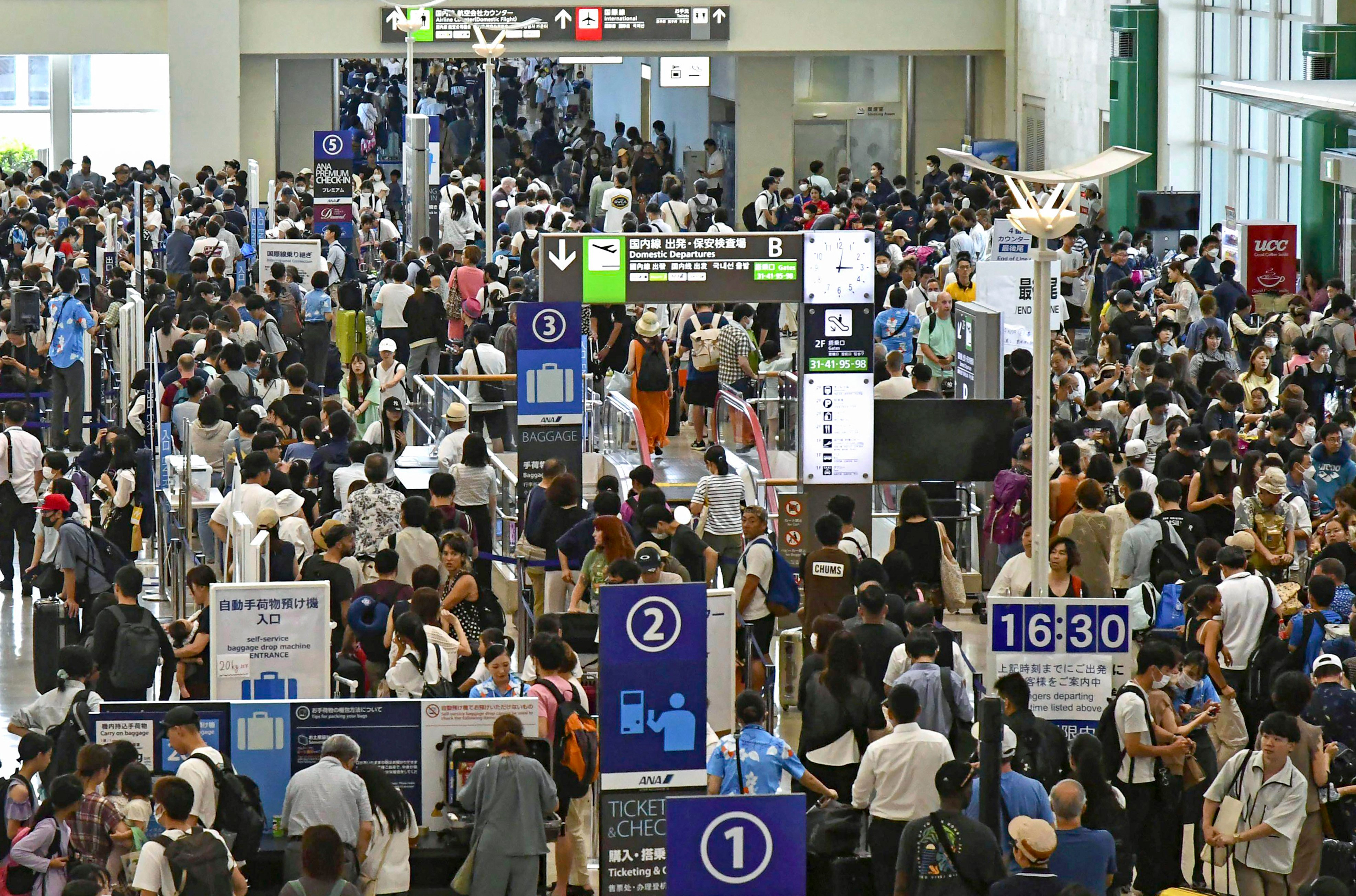 The airport is filled with people waiting for flights following cancellations caused by a typhoon hitting Okinawa in Japan. Photo: AP