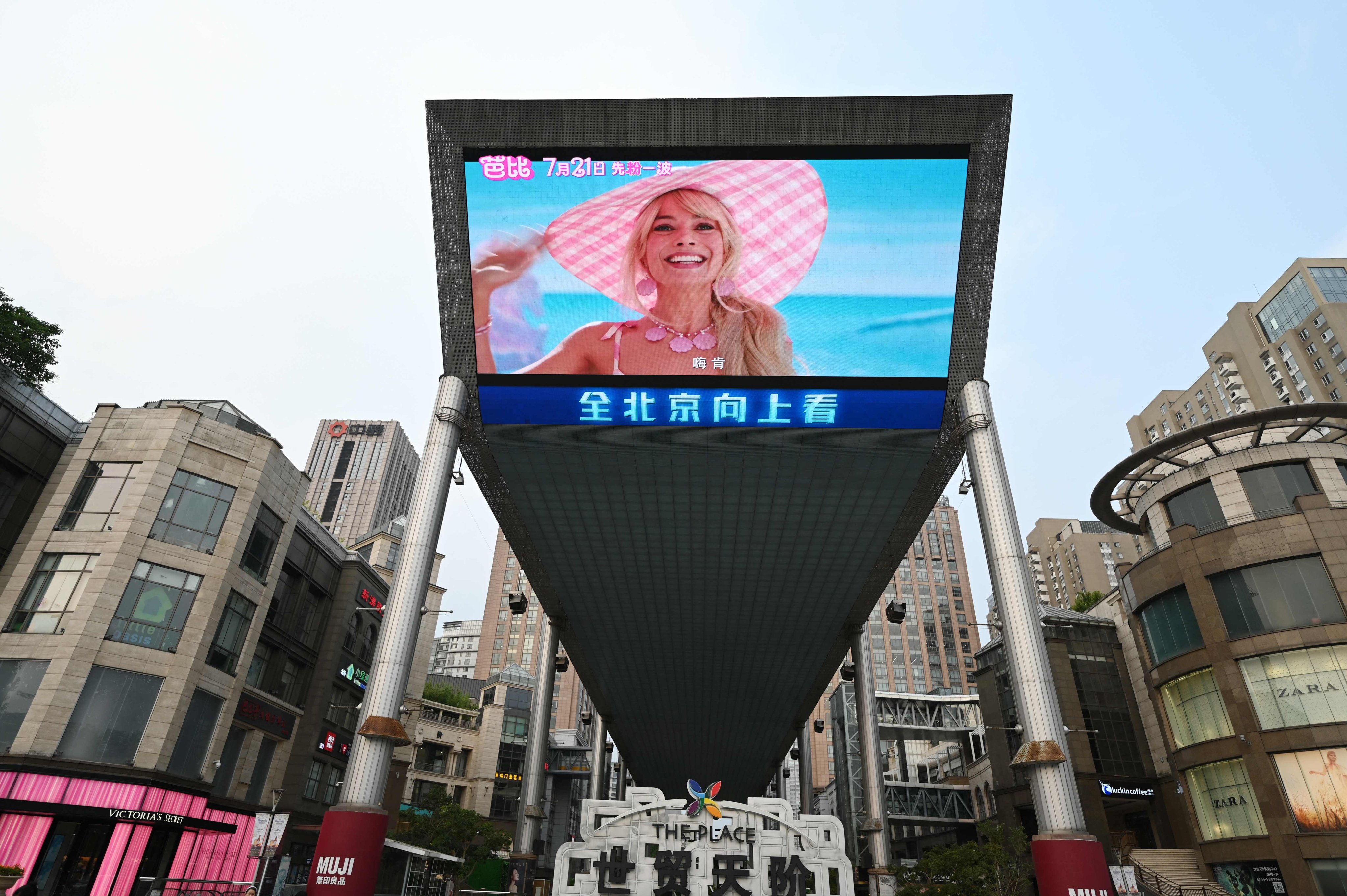 A trailer for the movie “Barbie” is shown on a giant screen outside a shopping mall in Beijing on July 20. Photo: AFP
