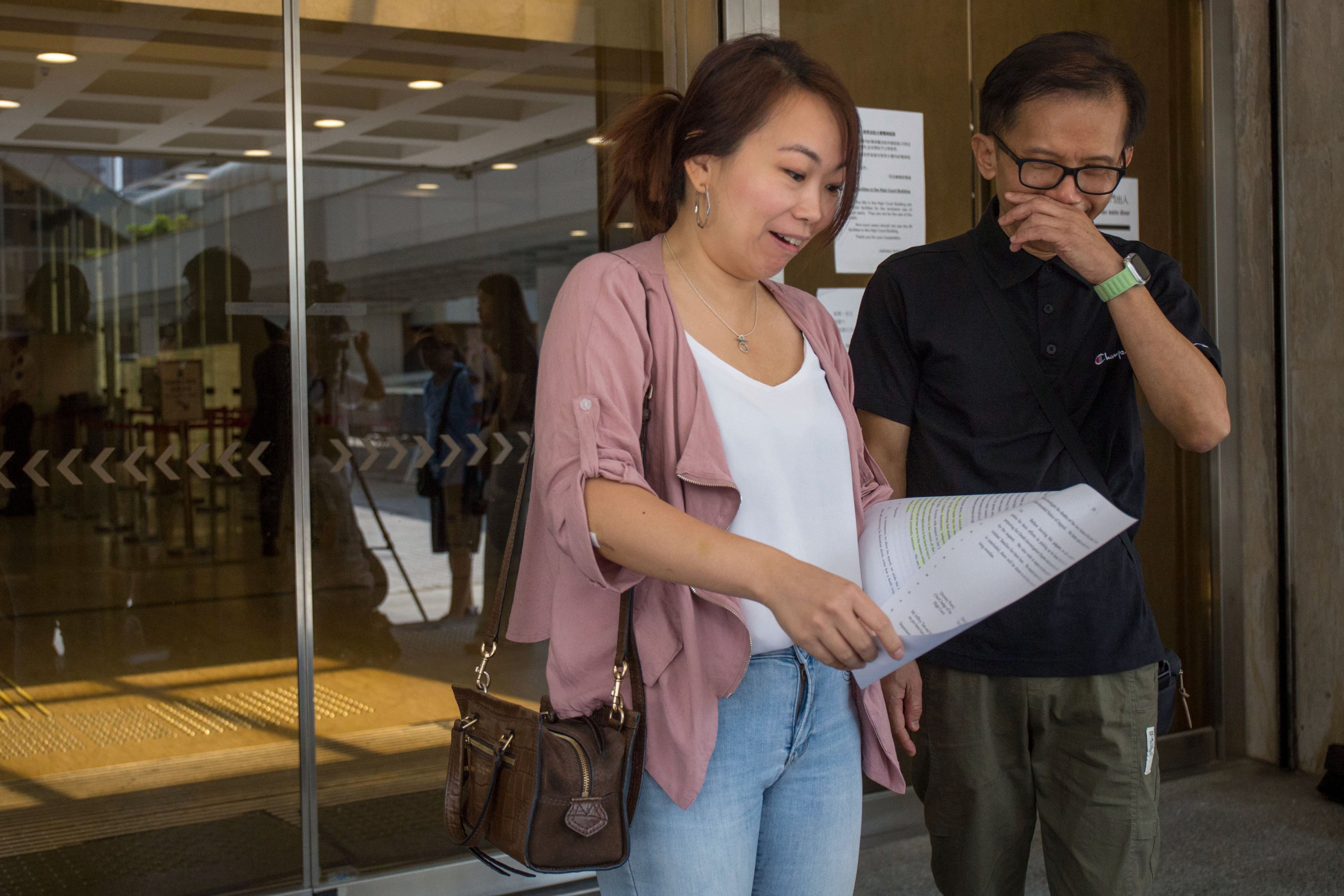 Alice Leung Suk-ling and Philip Chiu Ping-chuen outside the High Court upon learning of the recent ruling in favour of an inquest into the fatal ferry crash off Lamma Island in 2012. Photo: SCMP/Brian Wong