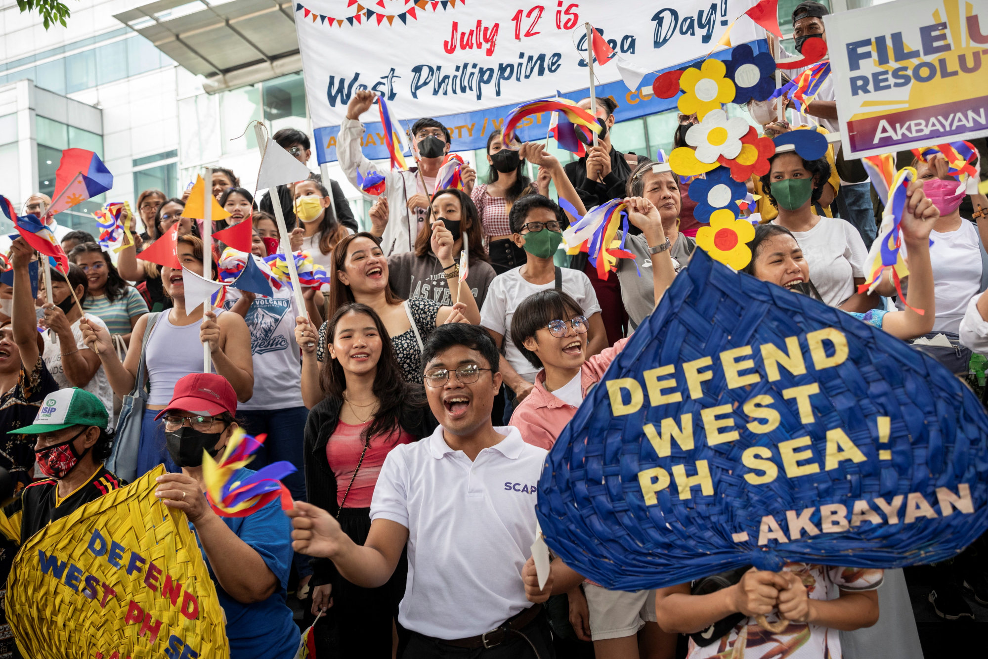 Activists gather outside the Chinese consular office to commemorate the anniversary of an international arbitral court ruling invalidating Beijing’s historical claims over the South China Sea, in Makati City, Metro Manila, on July 12. Photo: Reuters