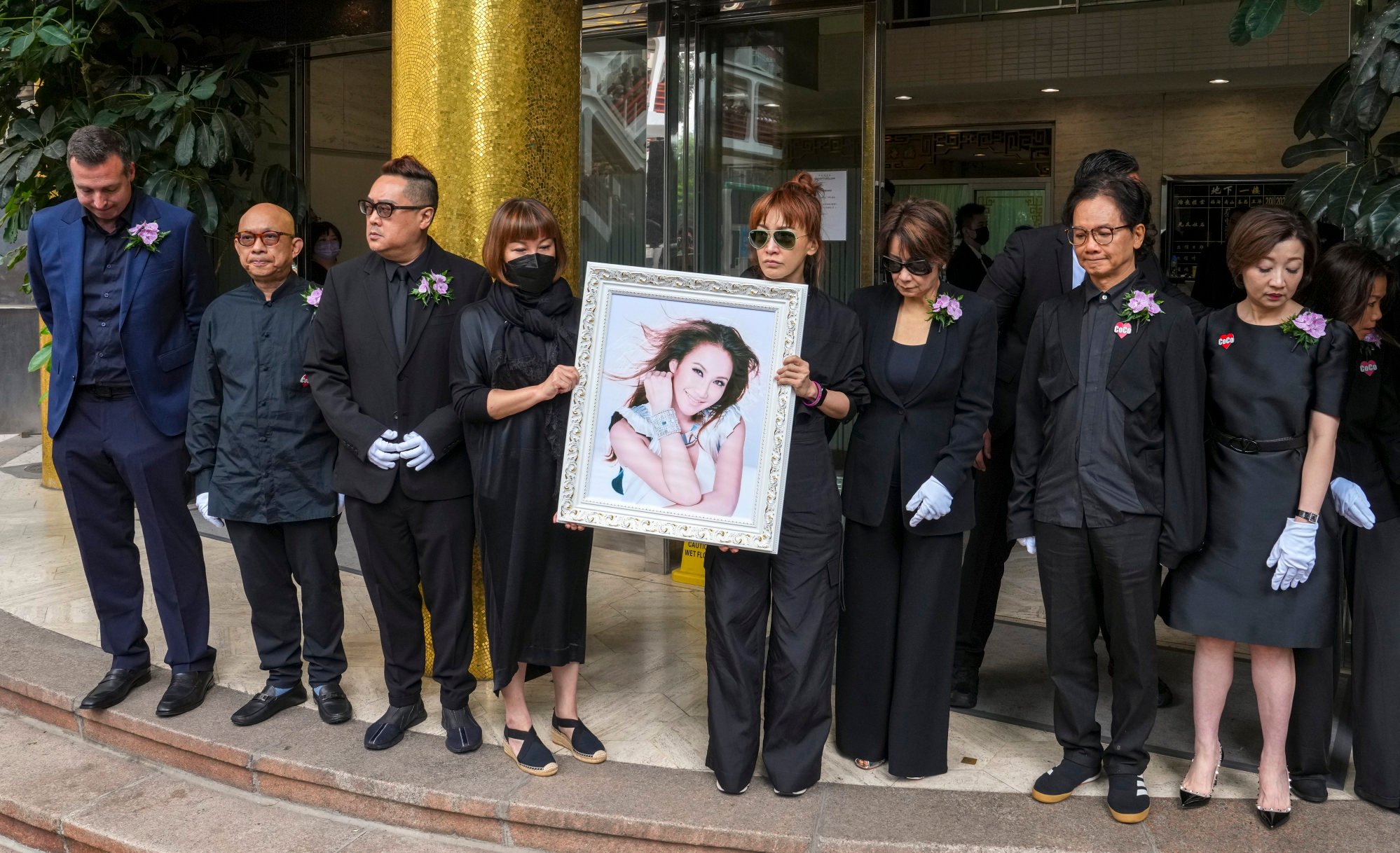 Family members and friends (left to right) Jonathan Serbin, Roger Li, Billy Ho, Carol Lee, Nancy Lee, Jenny Tseng, Chien Yao and Lily Pang leave a service for the late Coco Lee. Photo: Elson Li