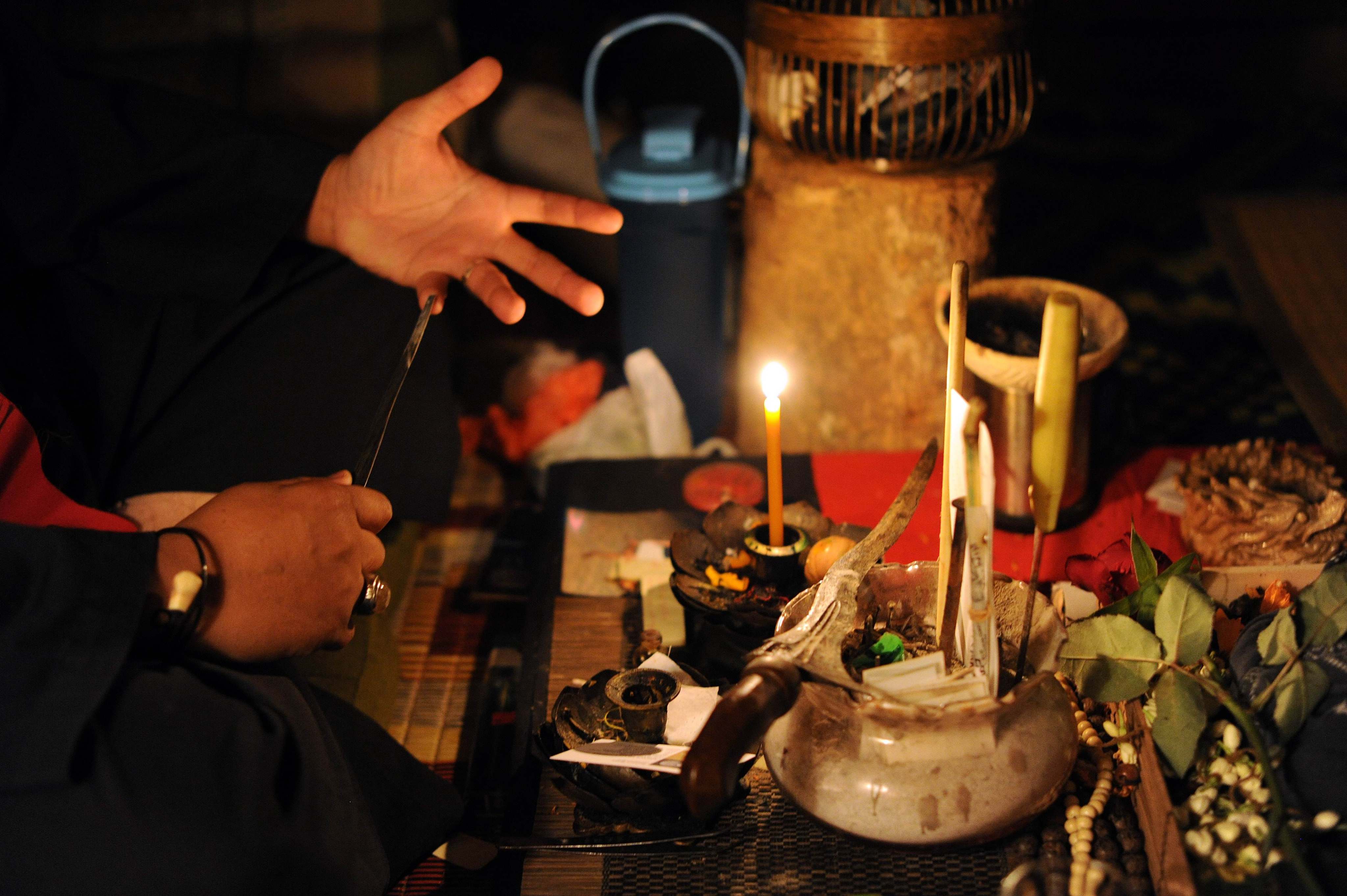 A self-professed witch doctor shows off his paraphernalia in Malaysia. Victims of “black magic” scams often claim they have been put into a trance by the scammers. Photo: AFP