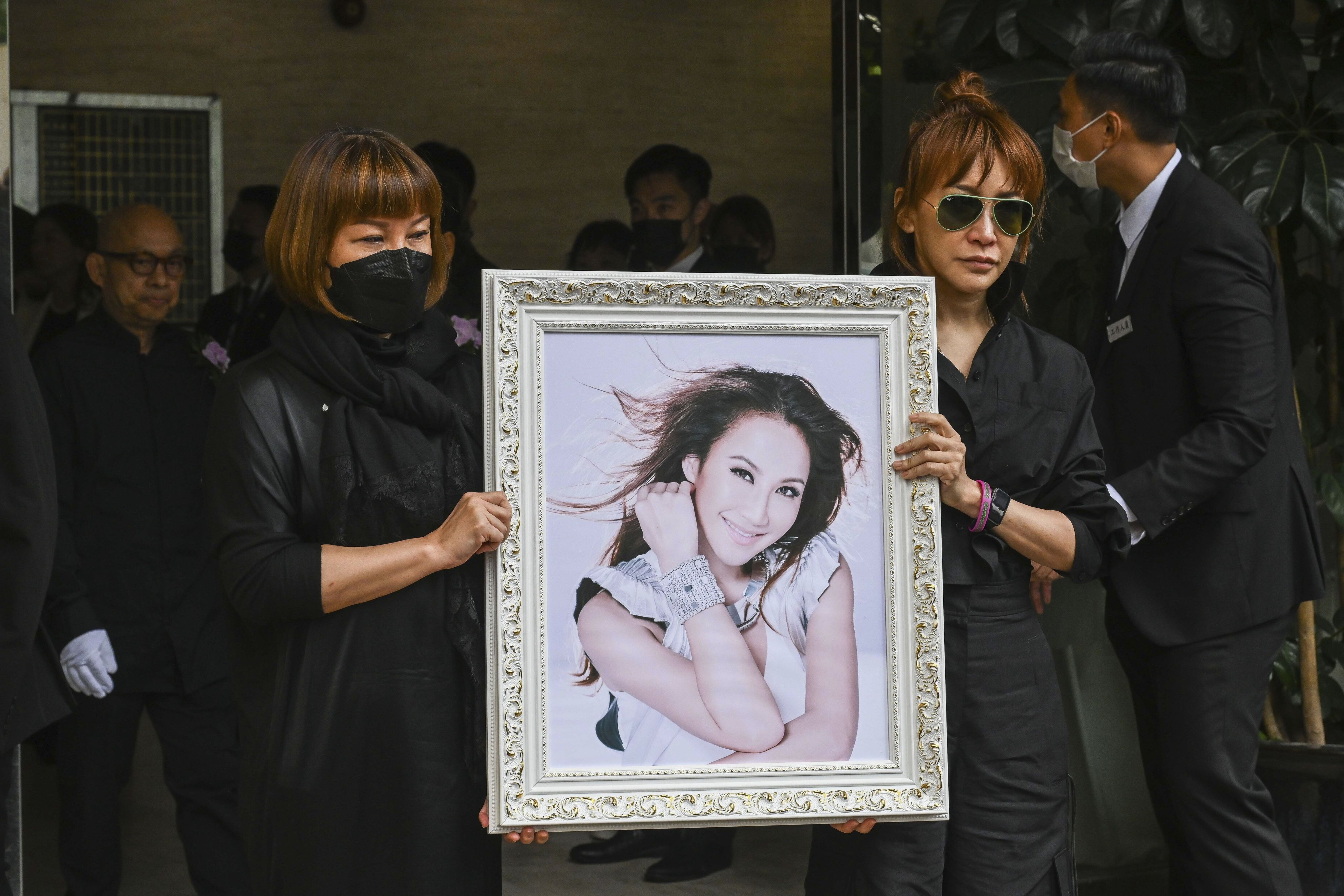 Relatives hold a photo of Coco Lee after her funeral in Hong Kong on August 1. Lee’s death has sparked a renewed focus on mental health in Hong Kong. Photo: AP