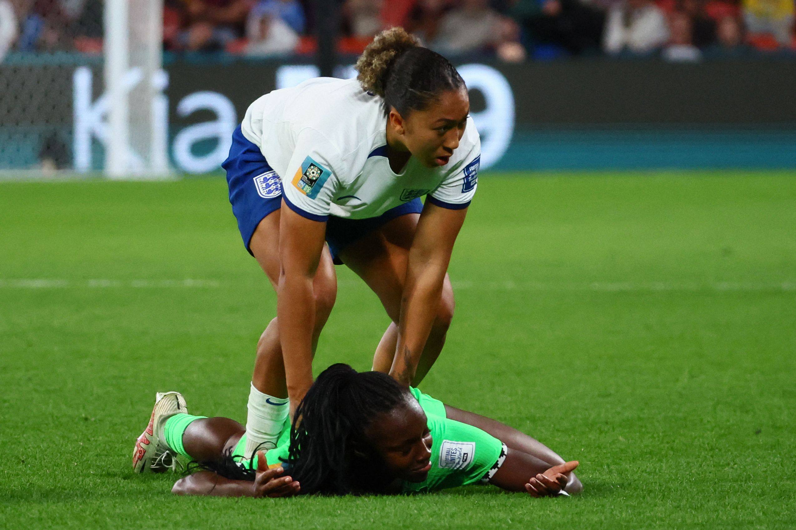 England forward Lauren James tries to help Nigeria defender  Michelle Alozie up after stamping on her. Photo: AFP
