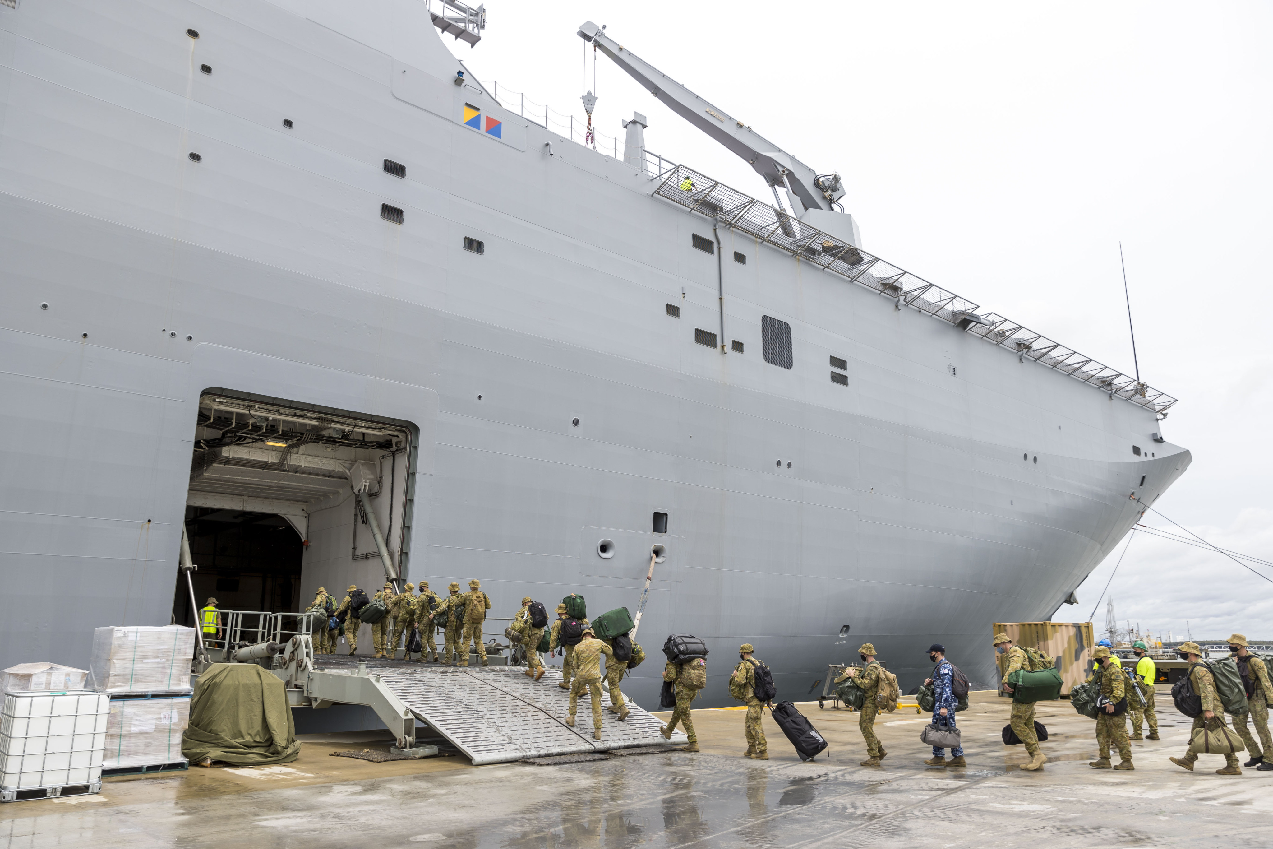 Australian soldiers load supplies onto HMAS Adelaide at the Port of Brisbane before departing for Tonga in January 2022, after a volcano eruption. Photo: Australia Defence Force via AP