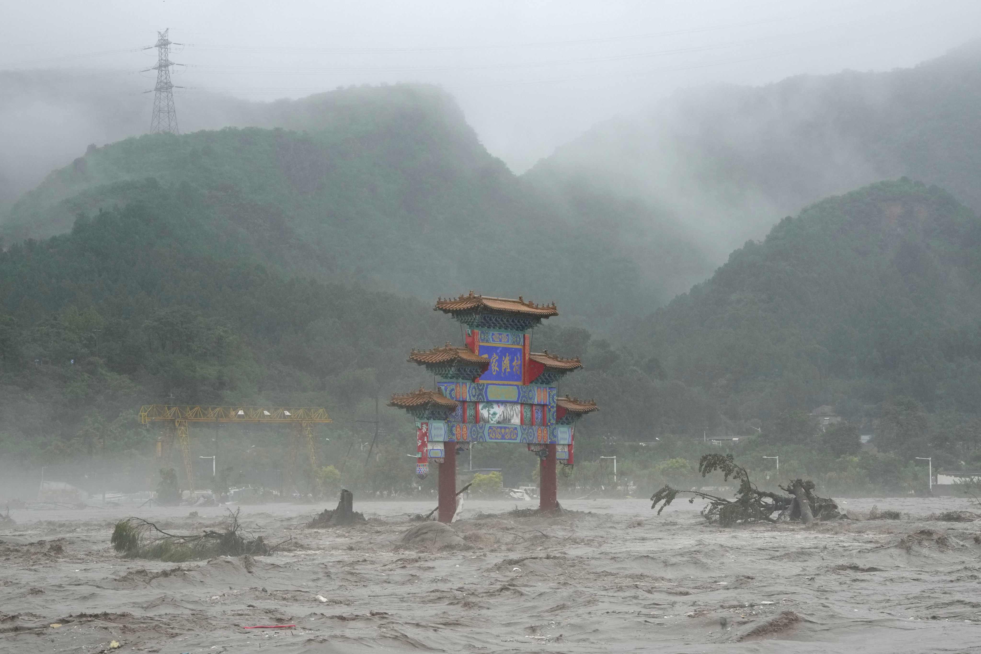 A traditional gate inundated by floodwaters on the outskirts of Beijing. Photo: AP