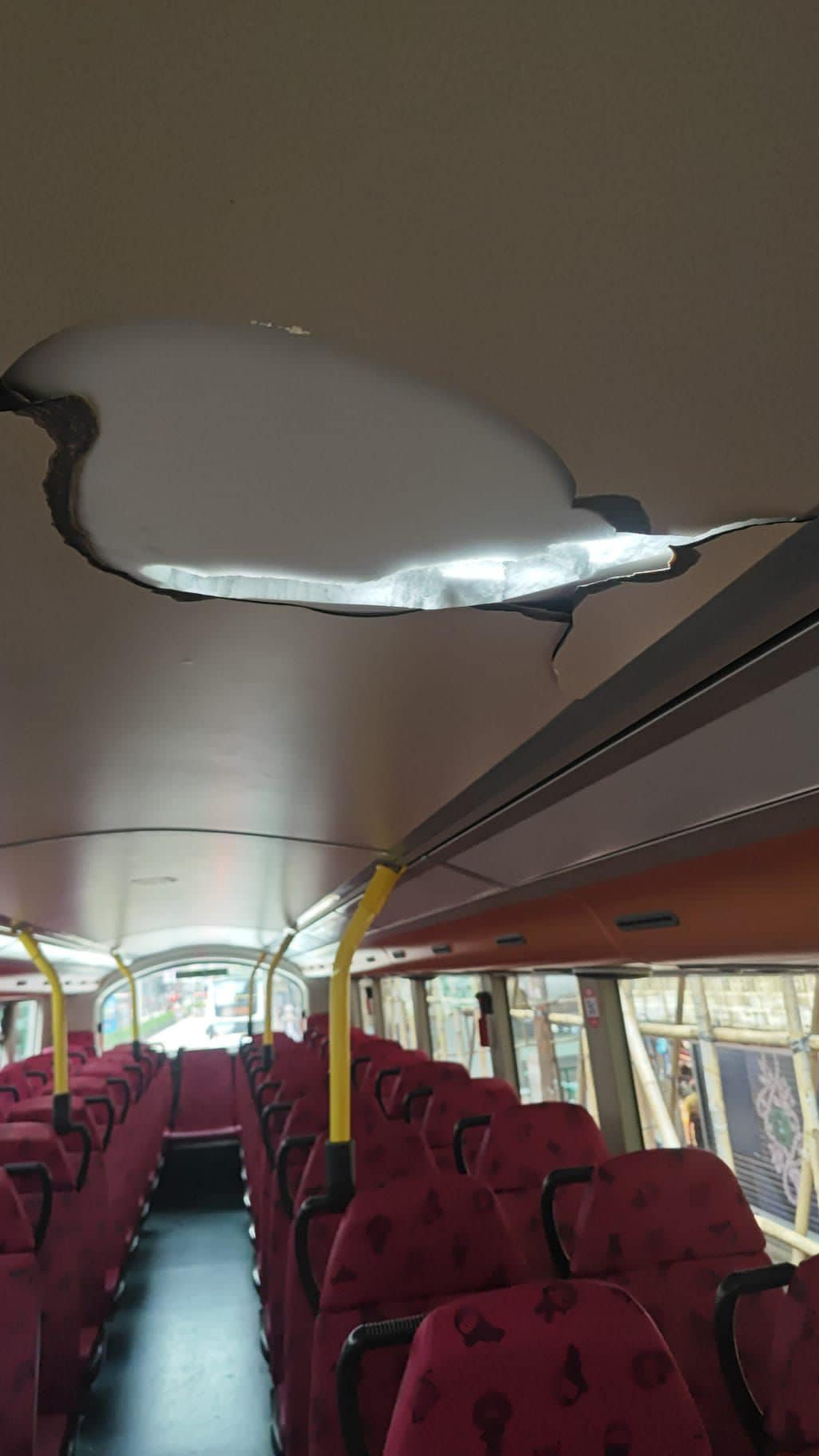 The falling concrete caused a hole in the roof of the double decker, but no injuries were reported. Photo: Handout The falling concrete caused a hole in the roof of the double decker, but no injuries were reported. Photo: Handout