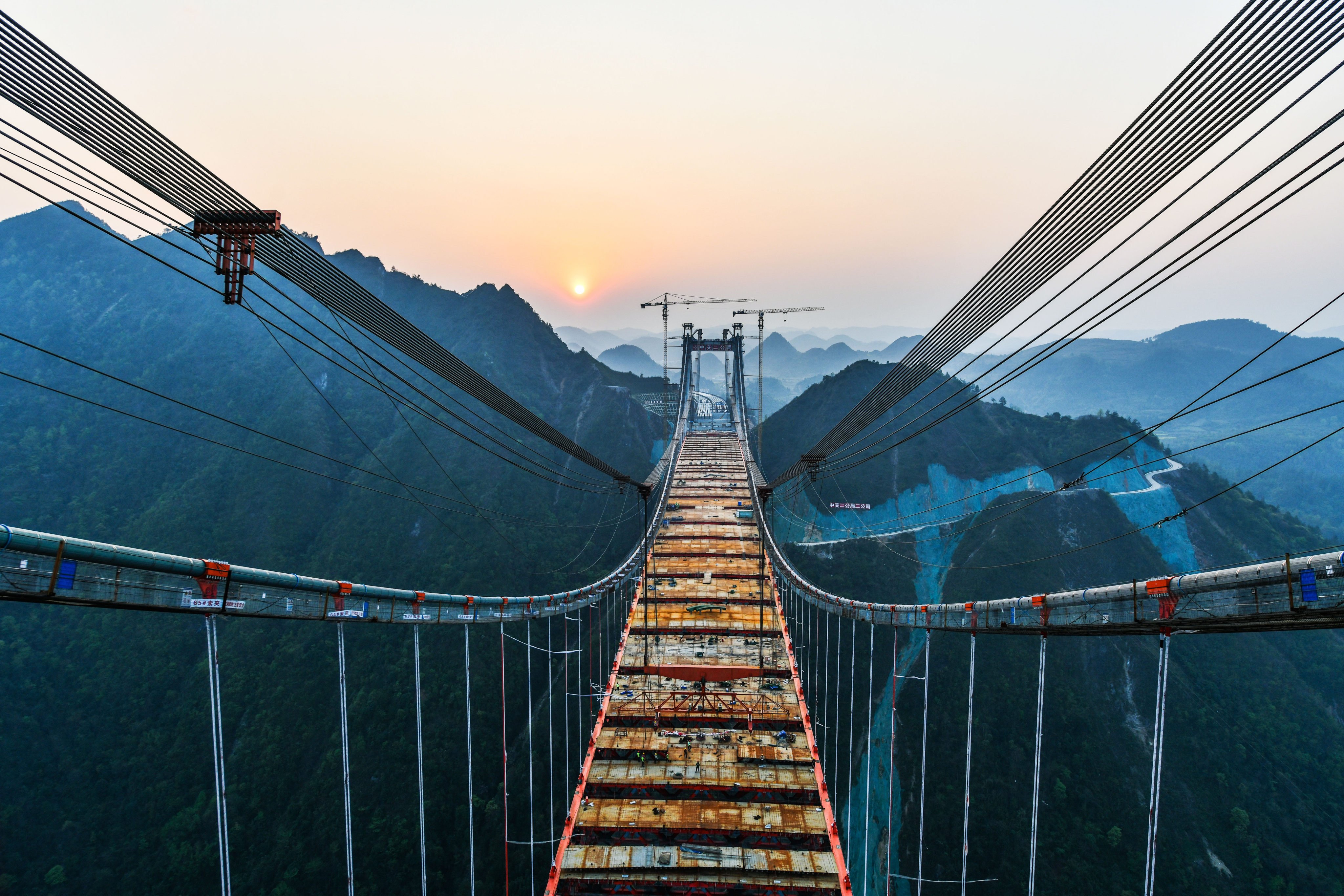 The Yangbaoshan grand bridge of the Guiyang-Huangping Highway at sunset, under construction on March 17, 2021 in Guizhou province. Guizhou has become known as a “bridge museum” of the world, with more than 28,000 highway bridges and almost half of the world’s tallest 100 bridges. Photo: Xinhua