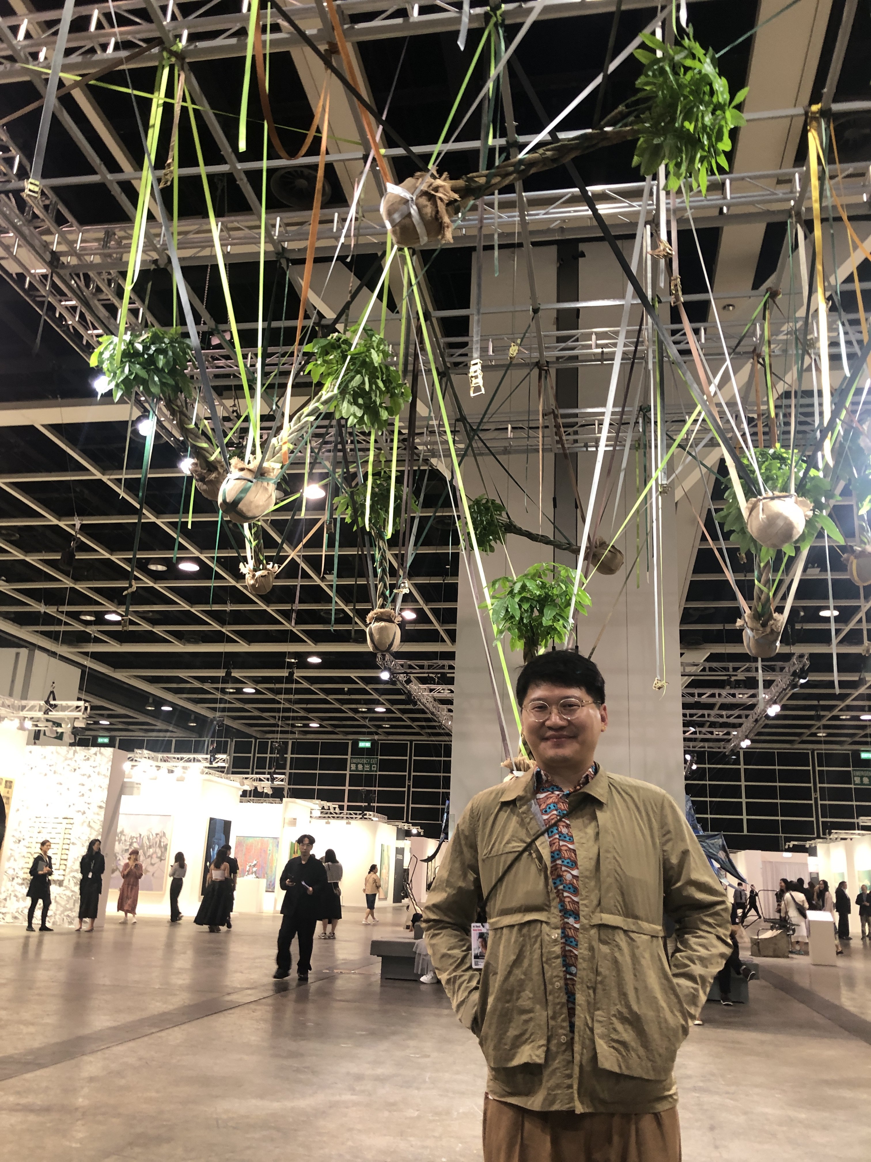 Artist Trevor Yeung photographed beneath his work “Mr. Cuddles Under the Eave” (2021) during Art Basel Hong Kong 2023. Yeung will represent Hong Kong at the Venice Biennale in 2024. Photo: Enid Tsui
