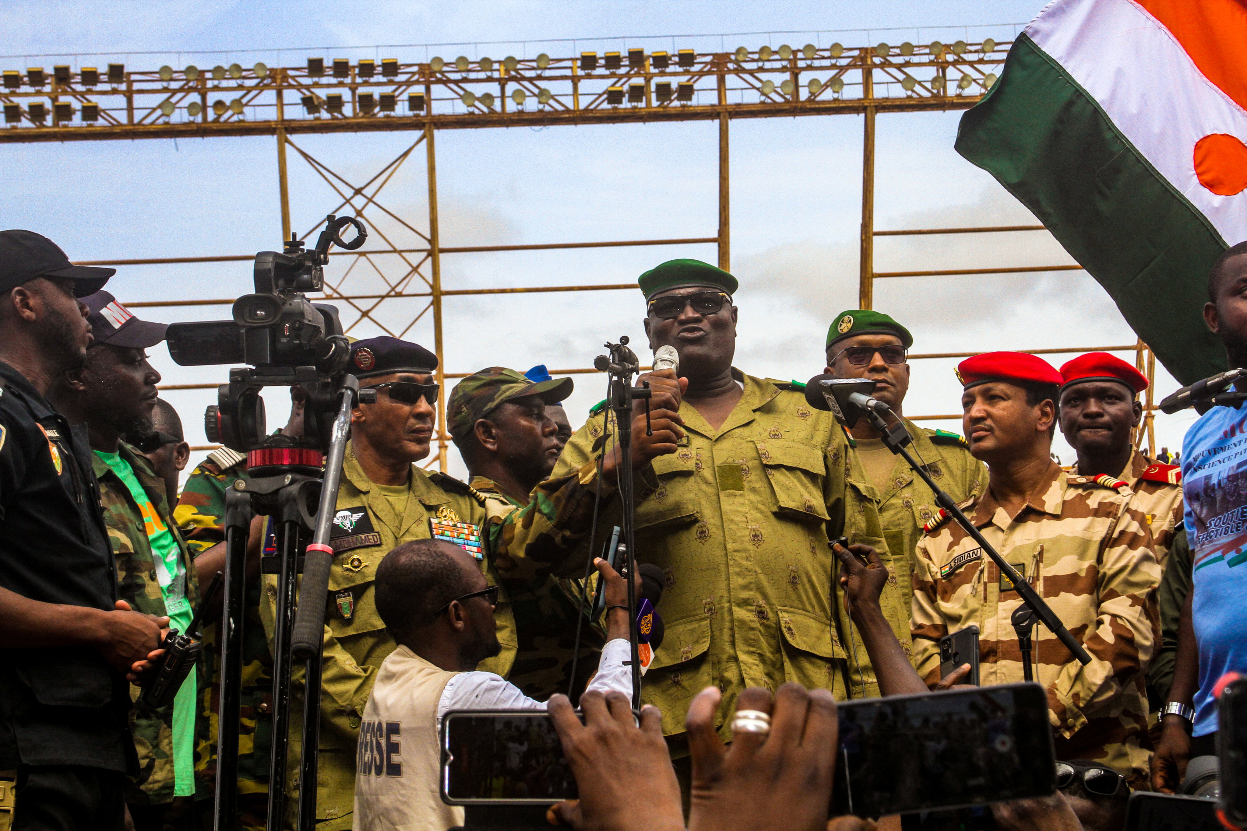 Members of a military council that staged a coup in Niger attend a rally at a stadium in Niamey. Photo: Reuters