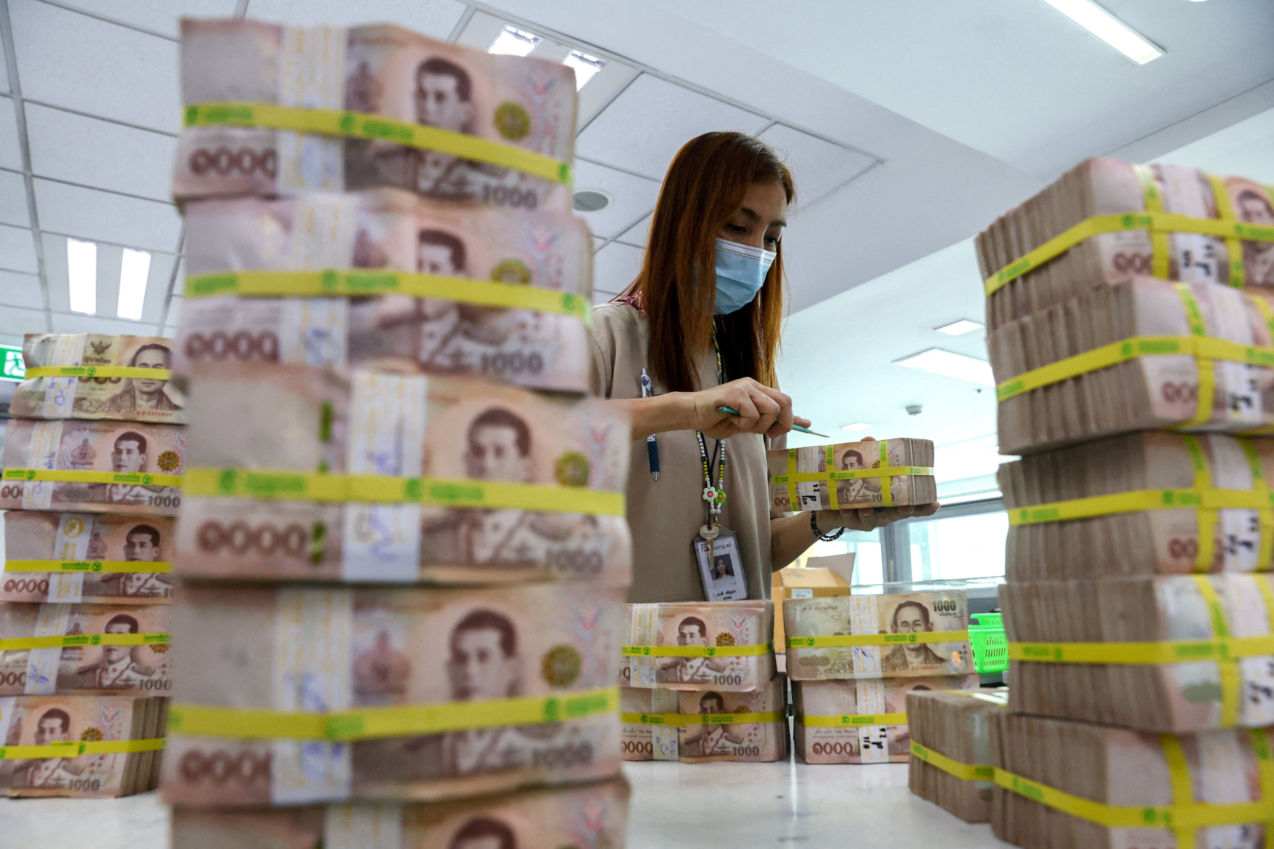Thai baht notes are stacked up at a Kasikornbank branch in Bangkok. Photo: Reuters