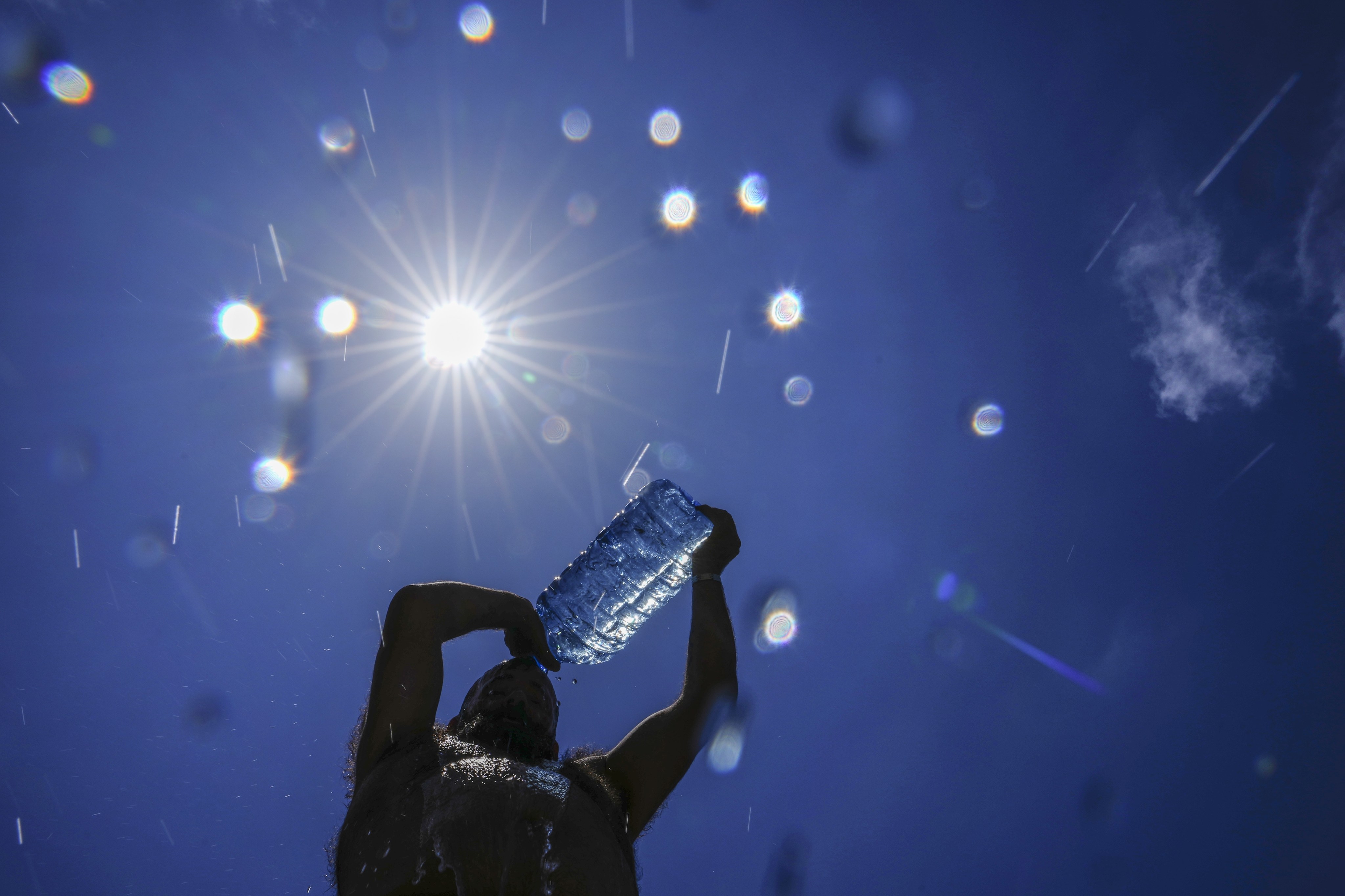 A man pours cold water onto his head to cool off on a sweltering hot day in Beirut, on July 16. Europea’s climate monitoring organisation made it official: July was Earth’s hottest month on record, by a wide margin. Photo: AP