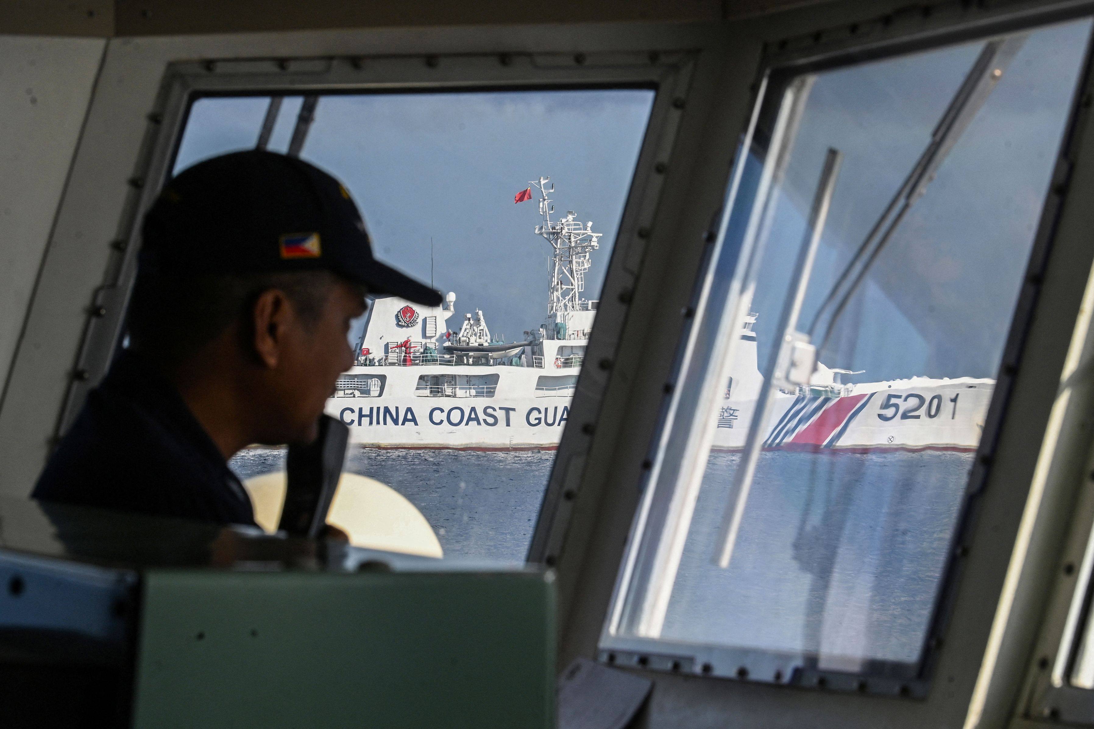 A member of the Philippine coast guard vessel BRP Malabrigo mans his post while being shadowed by a Chinese coast guard ship at Second Thomas Shoal in the Spratly Islands in the disputed South China Sea. Photo: AFP