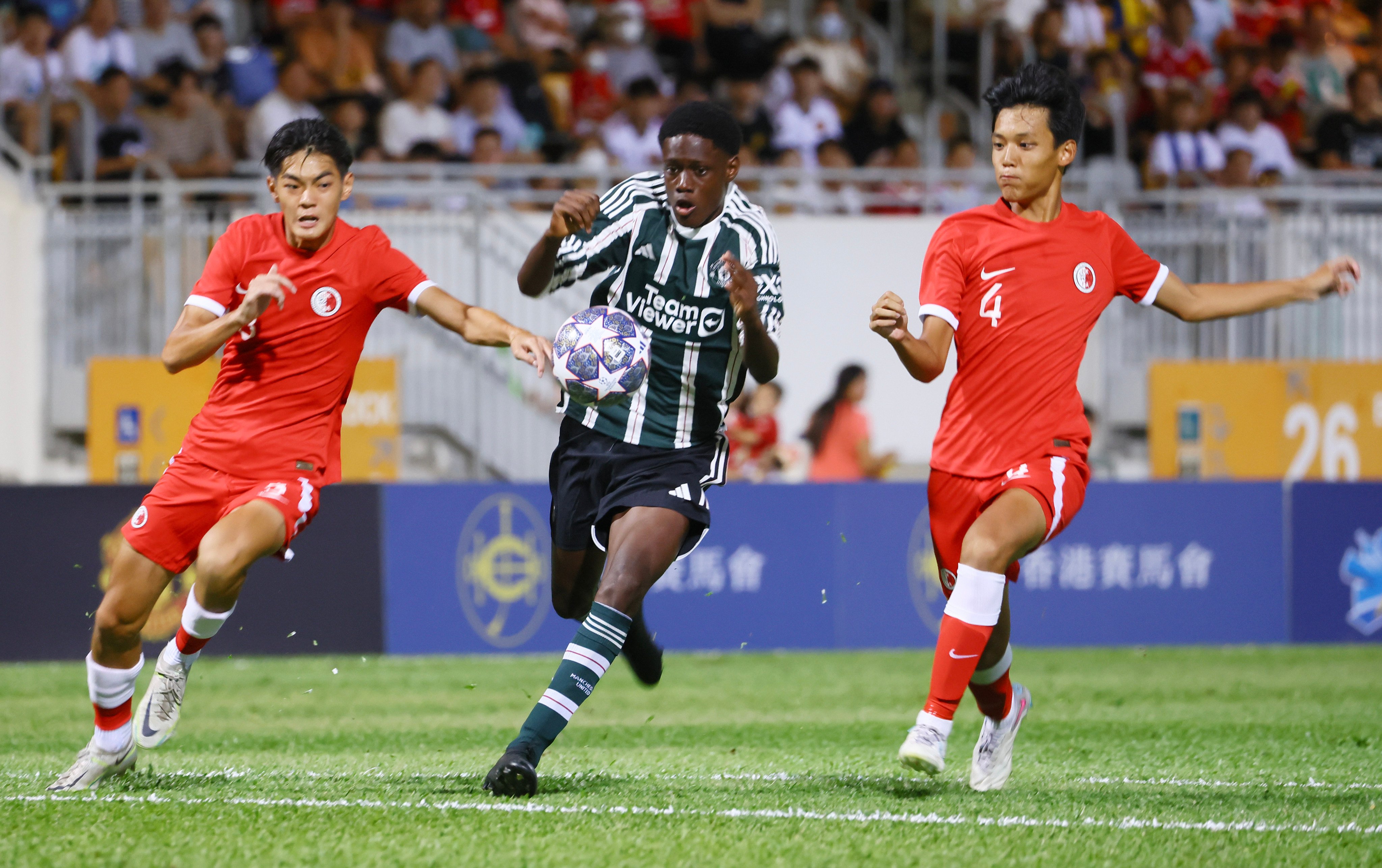 Manchester United Academy Under-16 player Bendito runs through Hong Kong defenders Lam Chin-yu and Ma Chin-ho at Mong Kok Stadium. Photo: Dickson Lee