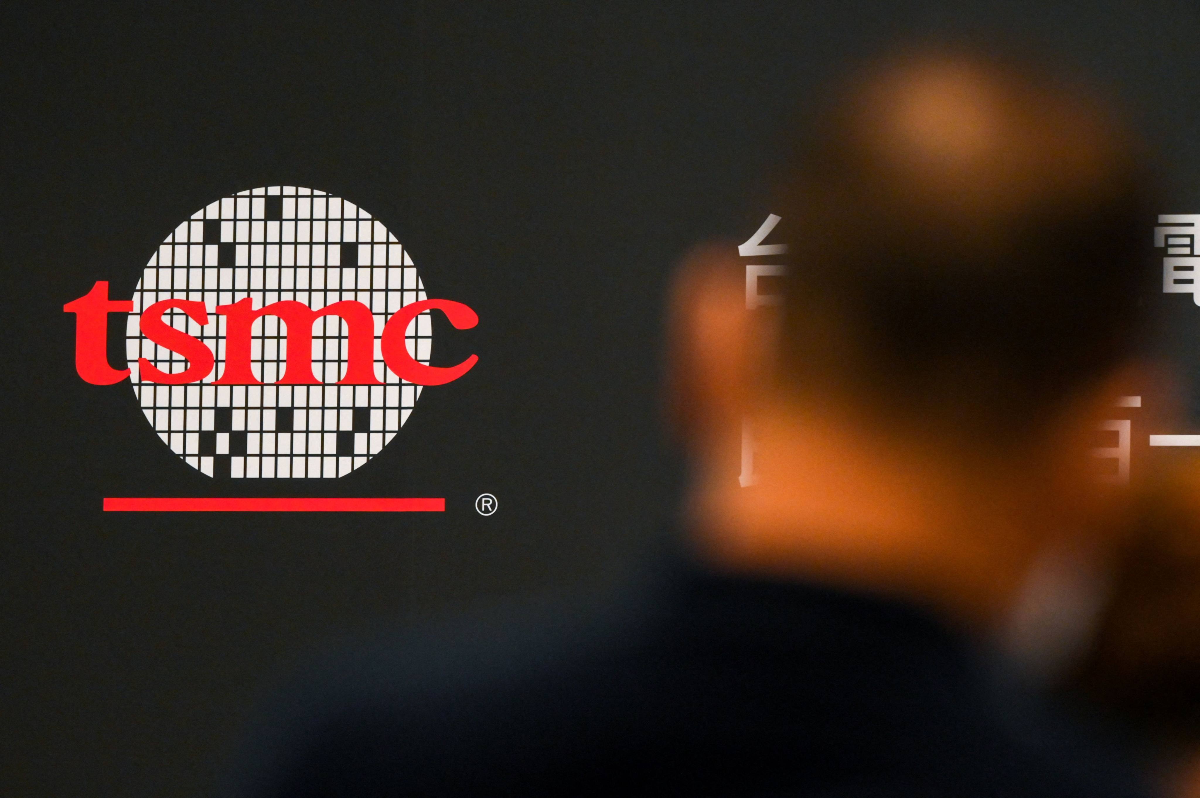 A man walks past a logo of Taiwan Semiconductor Manufacturing Co (TSMC) during a shareholders’ meeting in Hsinchu on June 6, 2023. Photo: AFP