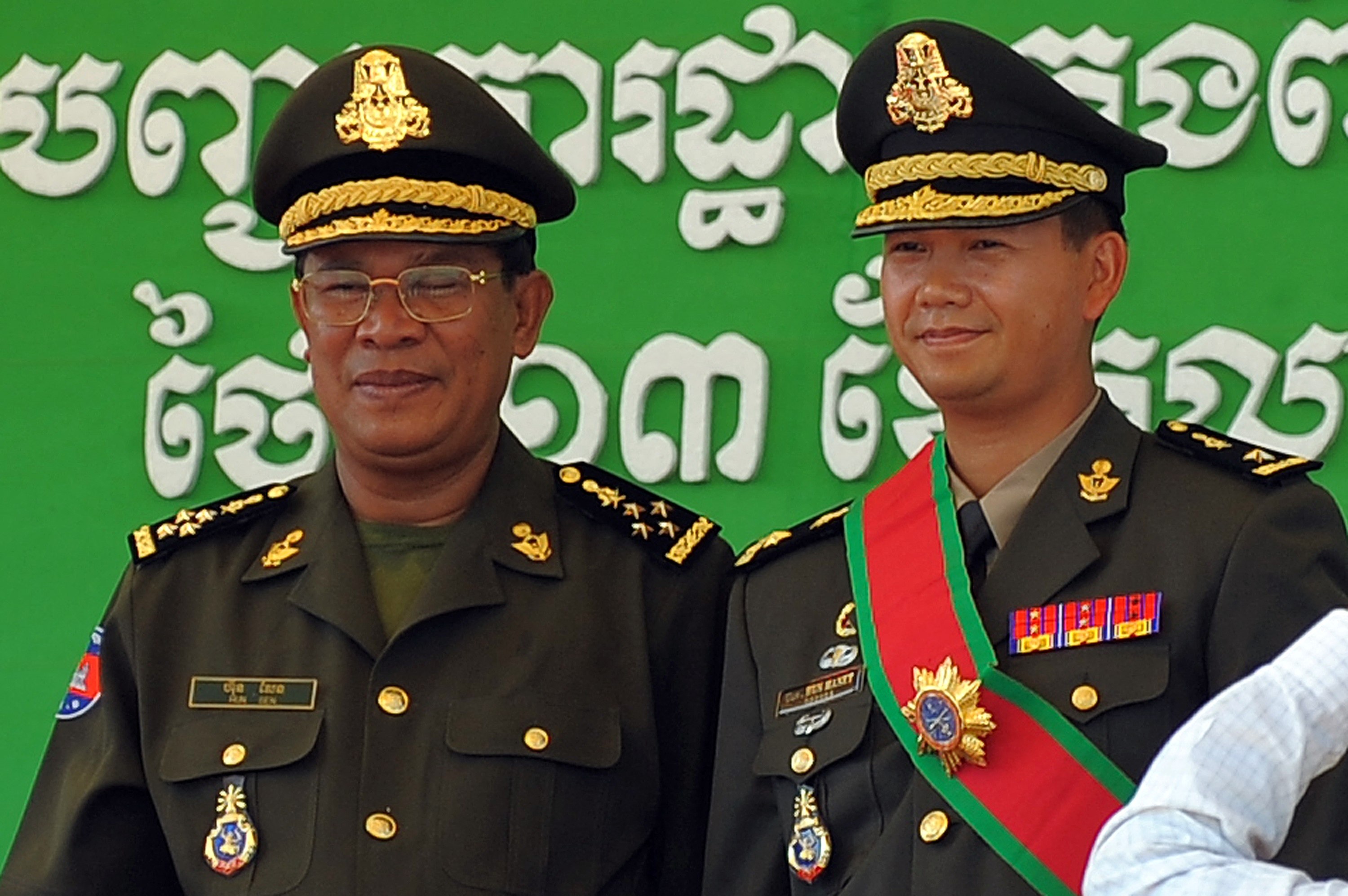Cambodia’s Prime Minister Hun Sen (left) poses with his son Hun Manet (right) during a ceremony at a military base in Phnom Penh on October 13, 2009. Photo: AFP