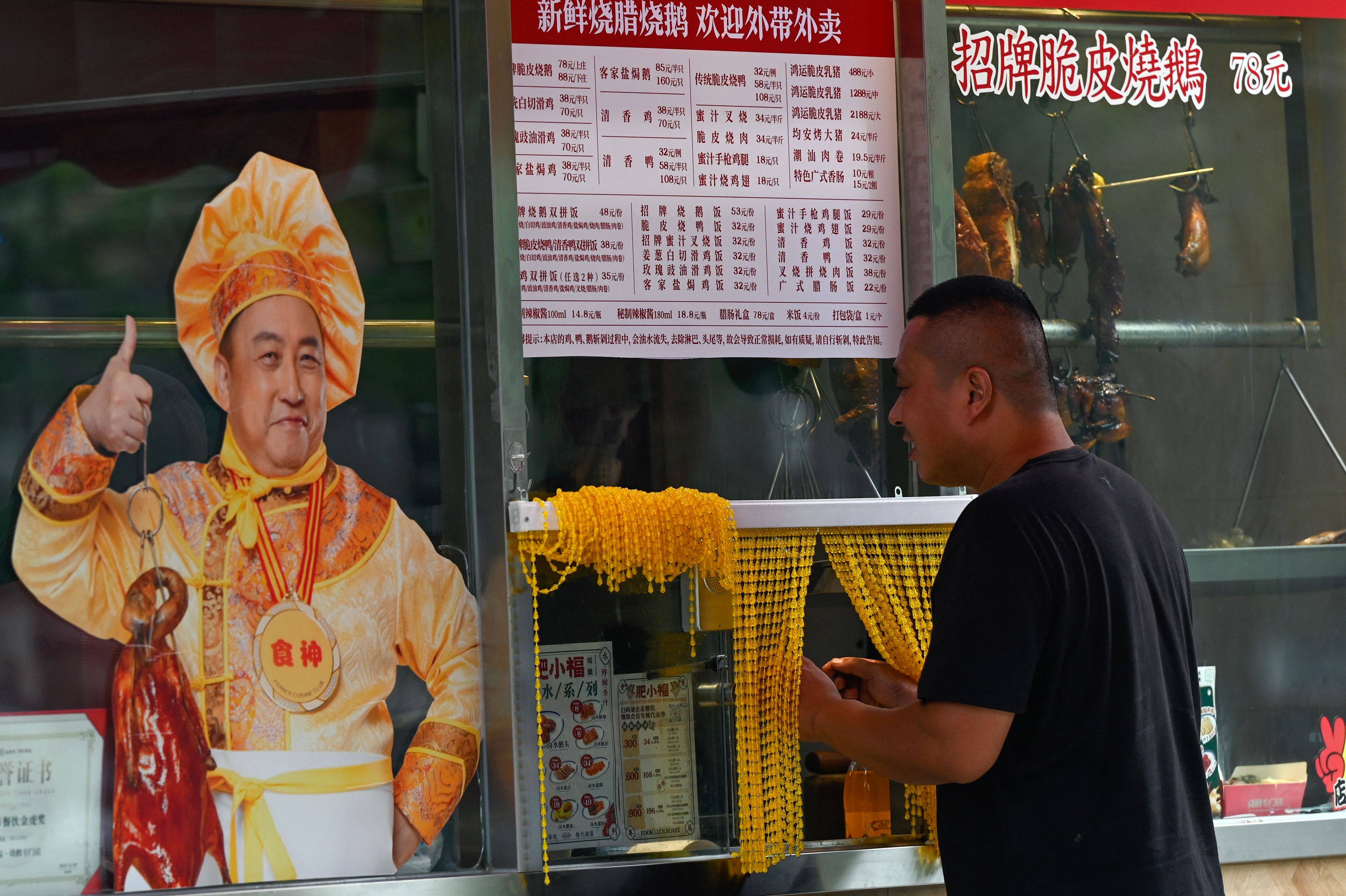 A customer buys food at a Beijing market. Sentiment towards China’s economy has soured in recent months, but there is significant upside potential, given the right kind of policy support from the government. Photo: AFP