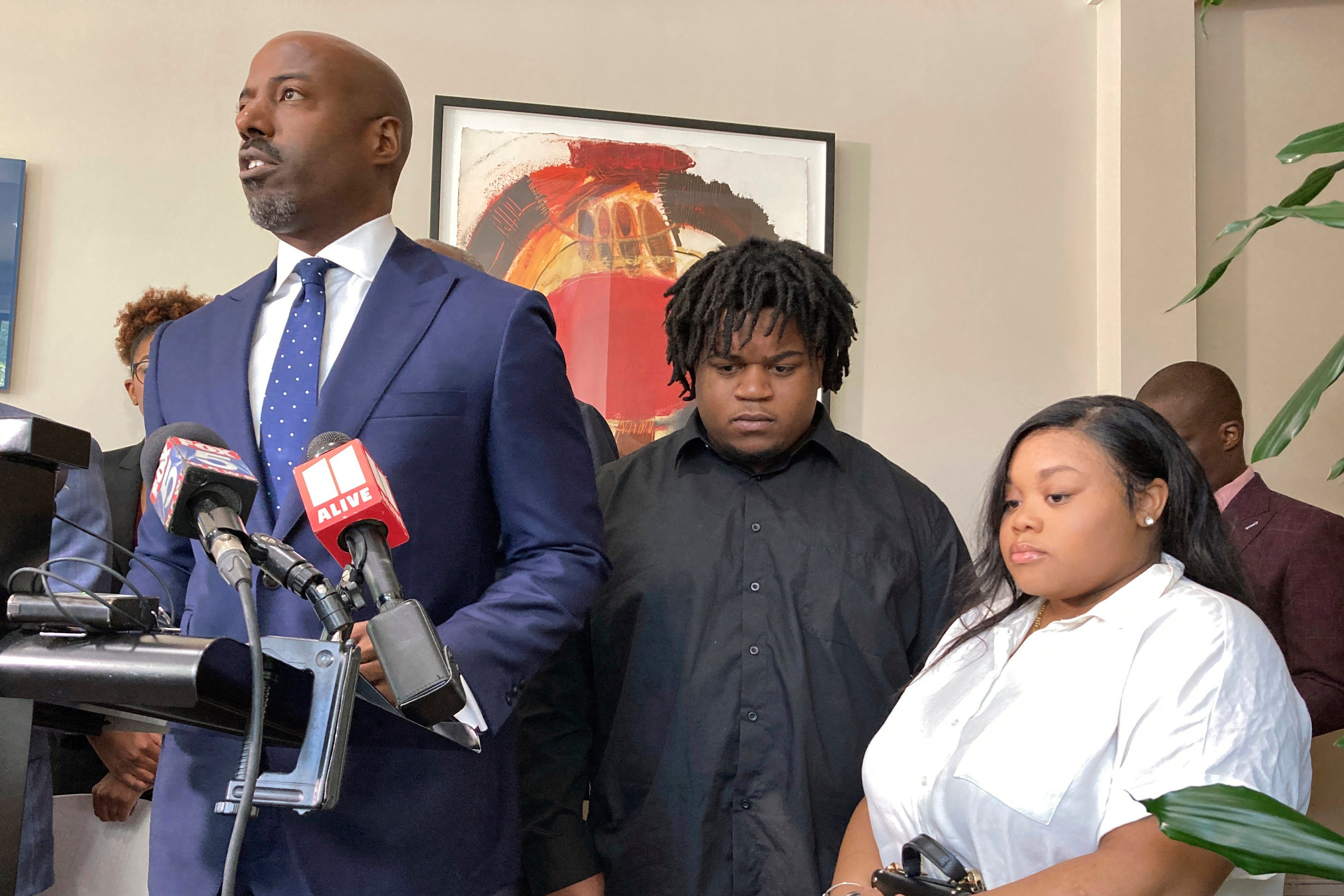 Lawyer Cory Lynch, joined by clients Treveon Isaiah Taylor Snr and Jessica Ross, speaks during a news conference in Atlanta on Wednesday. Photo: AP