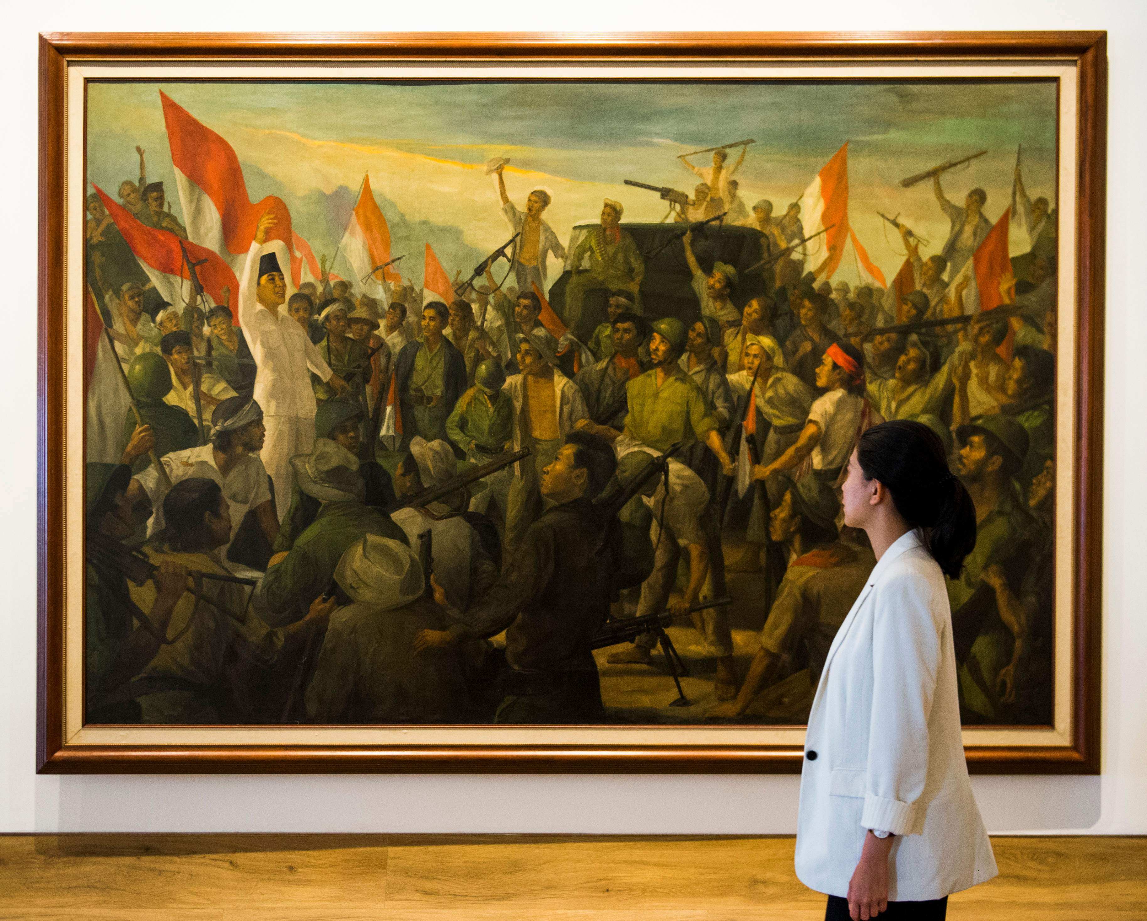 A woman walks past a painting titled ‘Revolutionary War’ at the Museum of Modern and Contemporary Art in Jakarta. Indonesian museums, especially in the provinces, are ill-equipped to handle the relics arriving from the Netherlands, experts say. Photo: AFP